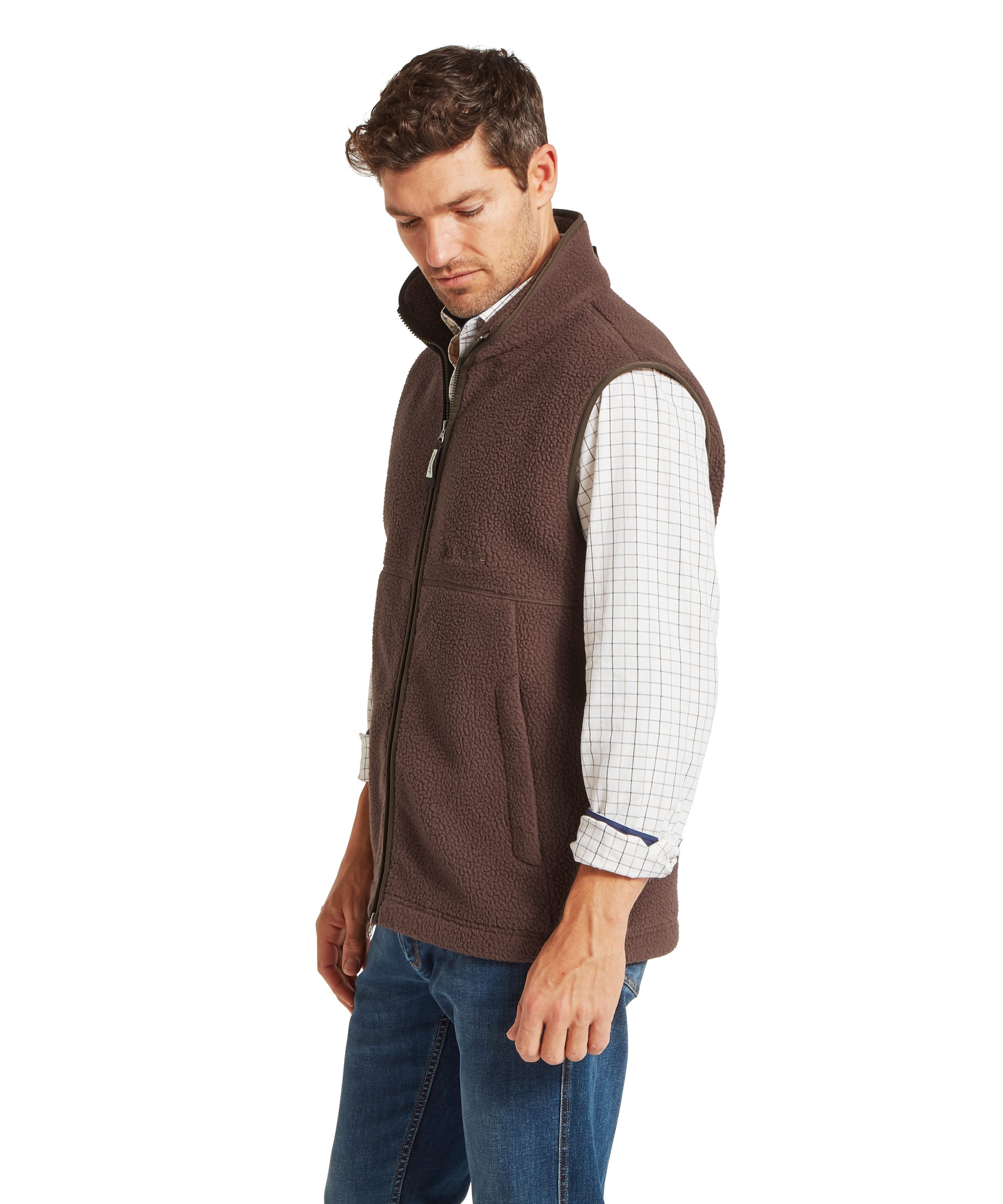 Schoffel Mens Oakham Retro Fleece Gilet in dark brown, three-quarter side view showing full-length zip, Schoffel chest logo, lower pockets and deep-pile sherpa fleece construction, worn over a check shirt