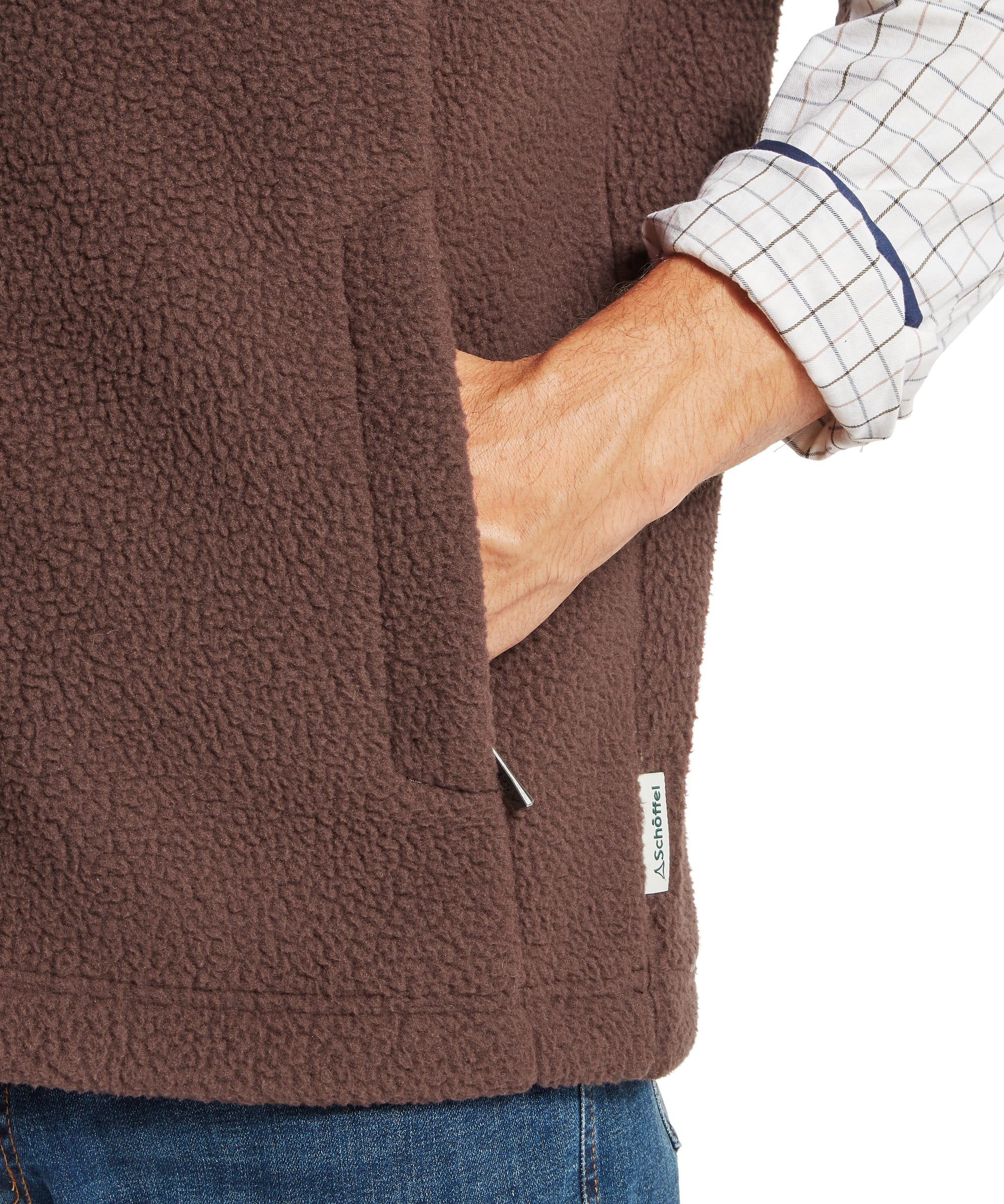 Close-up pocket detail of Schoffel Mens Oakham Retro Fleece Gilet in dark brown showing large lower hand-warmer pocket, deep-pile sherpa fleece texture and Schoffel woven label tab at hem