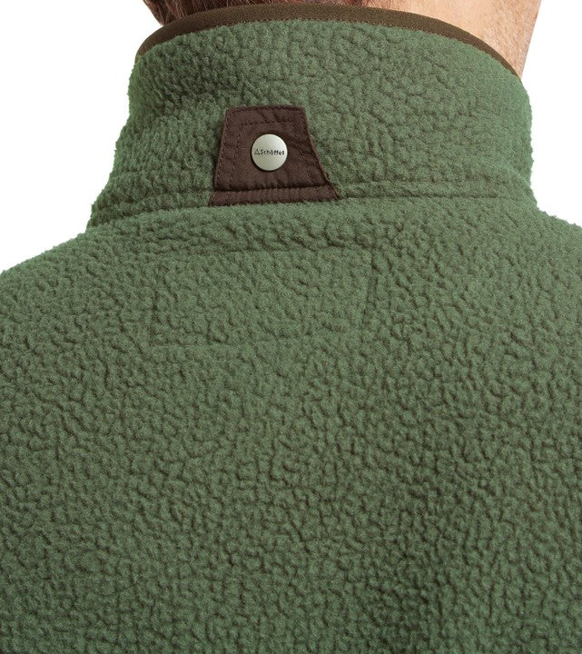 Close-up of a green fleece gilet  collar against a white background