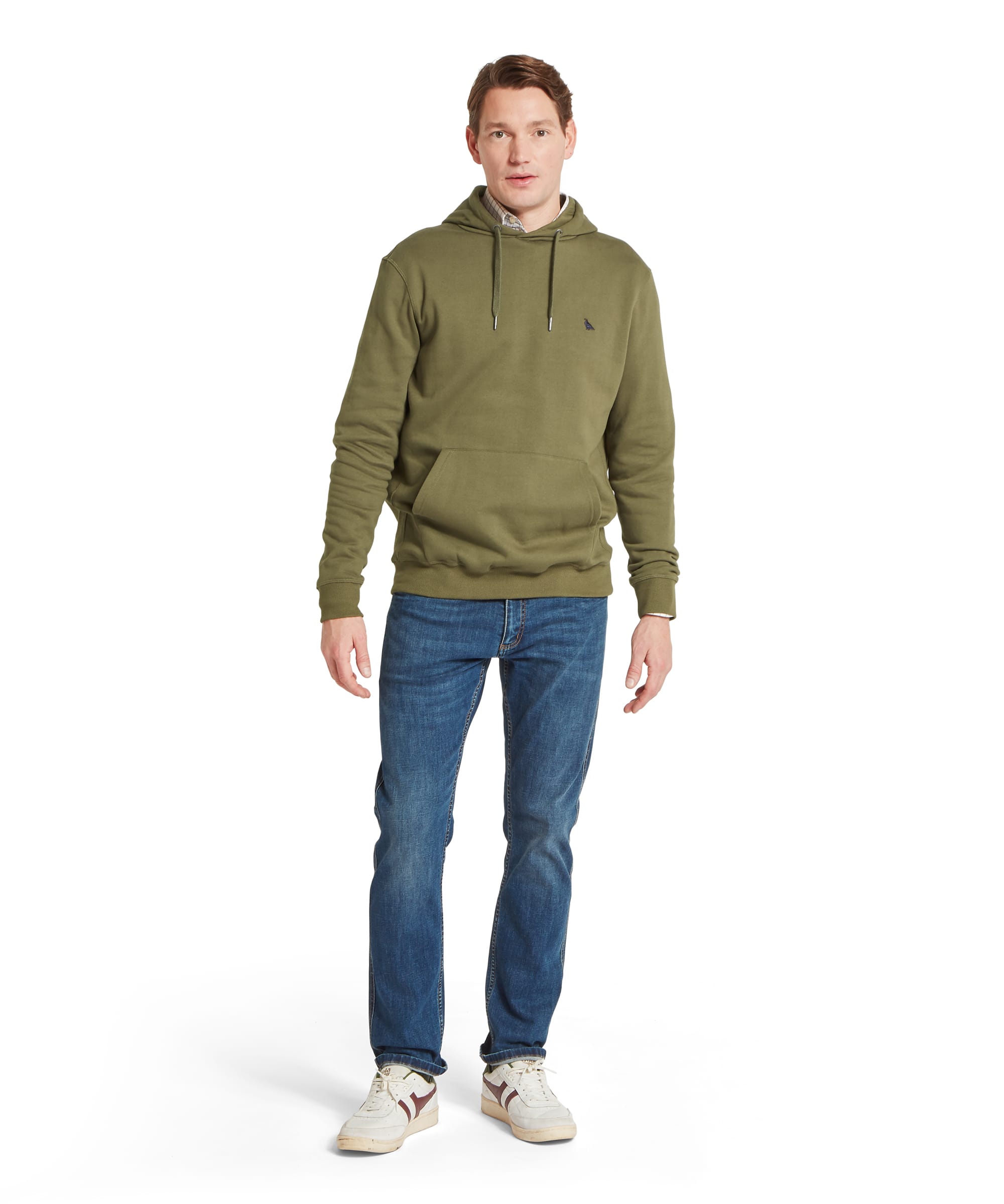 Schoffel Mens Pentire Heritage Hoodie in olive green worn with blue jeans and white trainers, full length front view showing drawstring hood, kangaroo pocket and relaxed country casual outfit