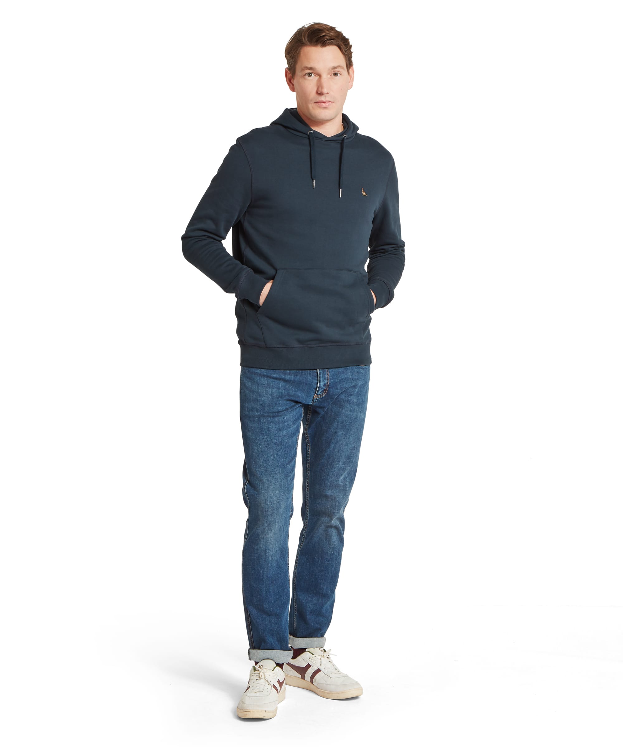 Schöffel Men's Pentire Heritage Hoodie in navy blue — full-length front view with hands in kangaroo pocket, paired with blue jeans and white trainers