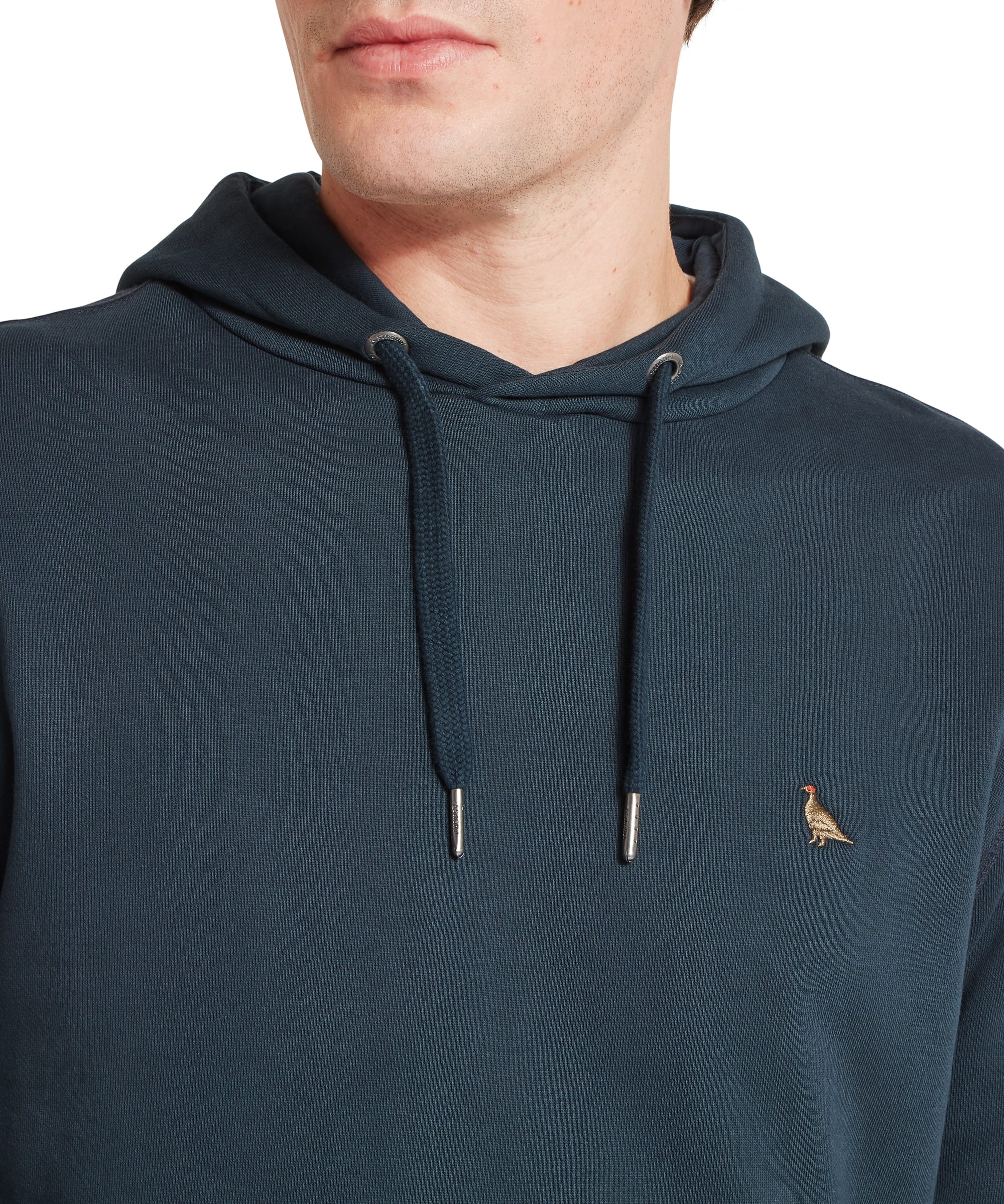 Schöffel Men's Pentire Heritage Hoodie in navy blue — three-quarter view highlighting the relaxed fit, raglan-style seams and kangaroo pocket, worn with blue jeans