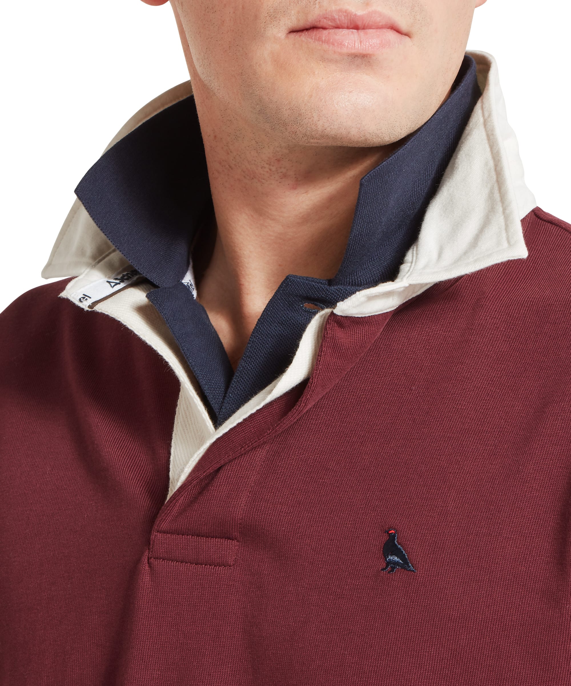 Schöffel Men's Porthallow Rugby Shirt in burgundy red — close-up of back neck area showing embroidered Schöffel logo and curved yoke seam detail
