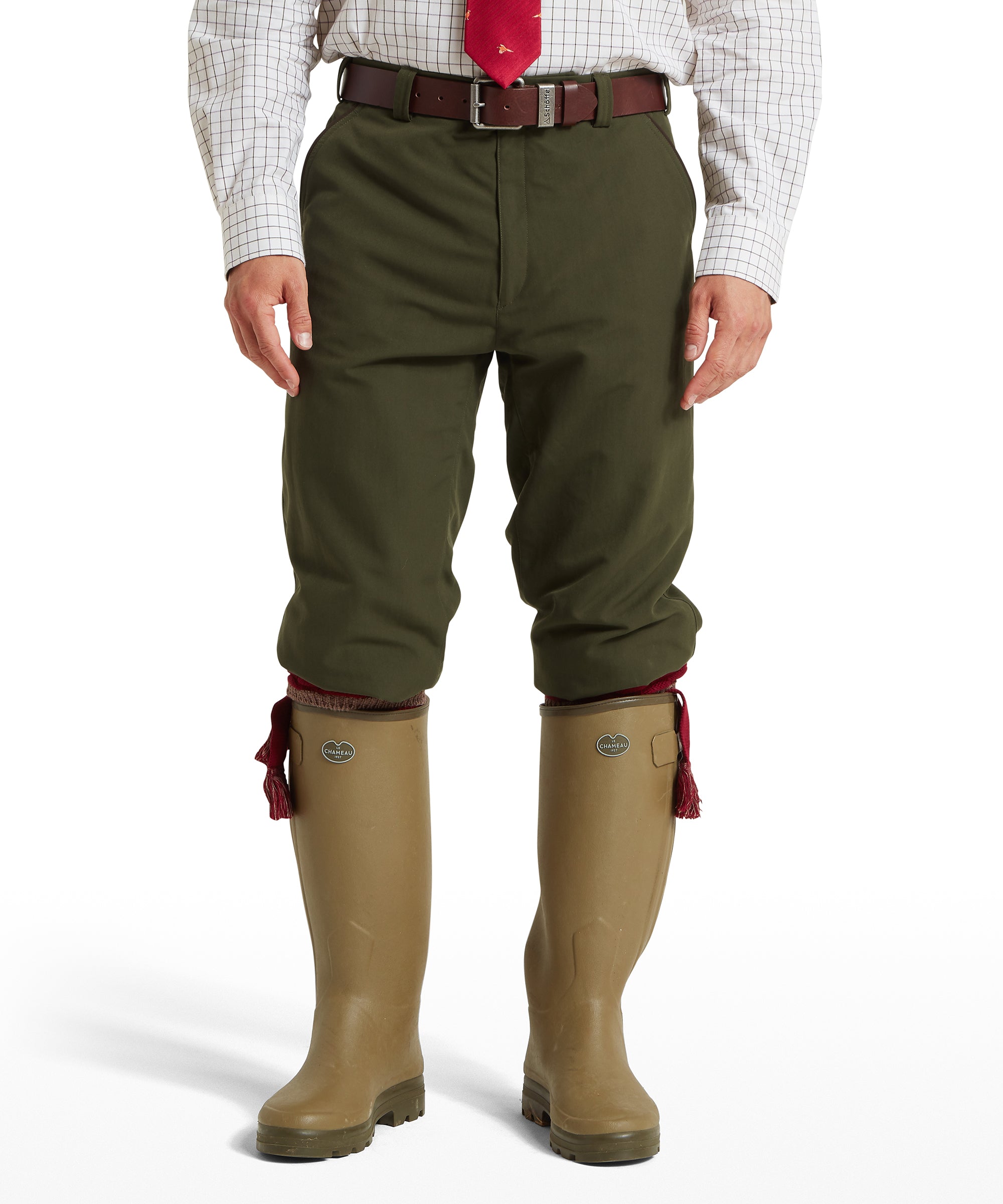 Man wearing Schöffel Ptarmigan Plus Twos breeks in green with brown leather belt and green wellington boots
