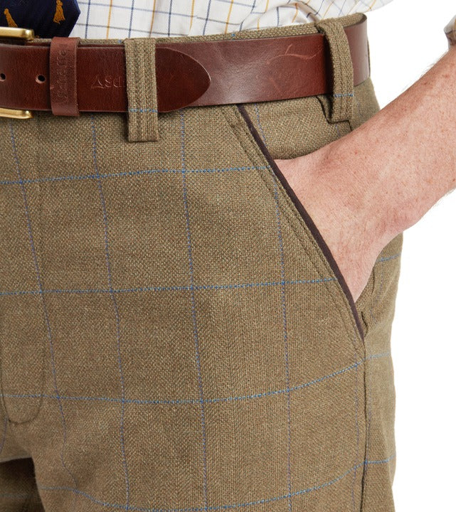 Schöffel Ptarmigan tweed plus twos in brown, close-up of windowpane check fabric with waistband and pocket detail, styled with leather belt