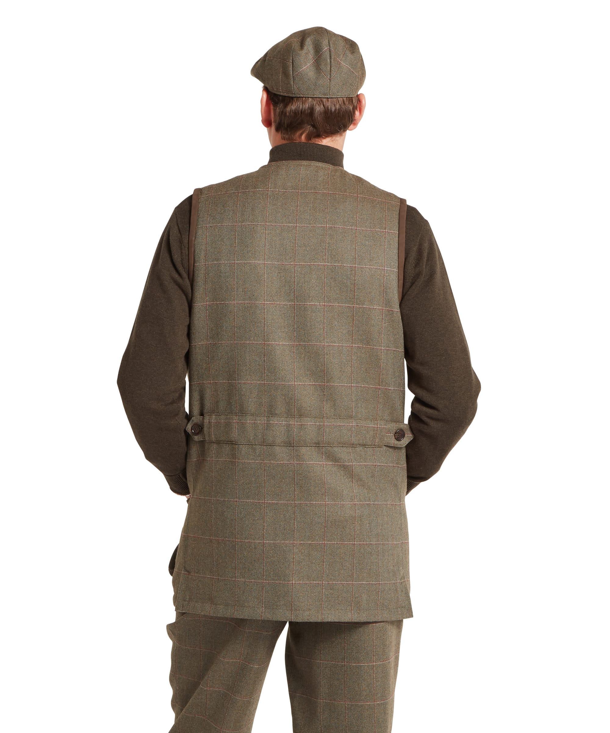 Schöffel Men's Ptarmigan Tweed Waistcoat II in Lovat brown windowpane check — close-up of the upper chest showing the large quilted suede shooting patch, V-neck opening, top button and Schöffel leather zip pull on the layered zip-neck gilet beneath, worn over a checked shirt and red tie