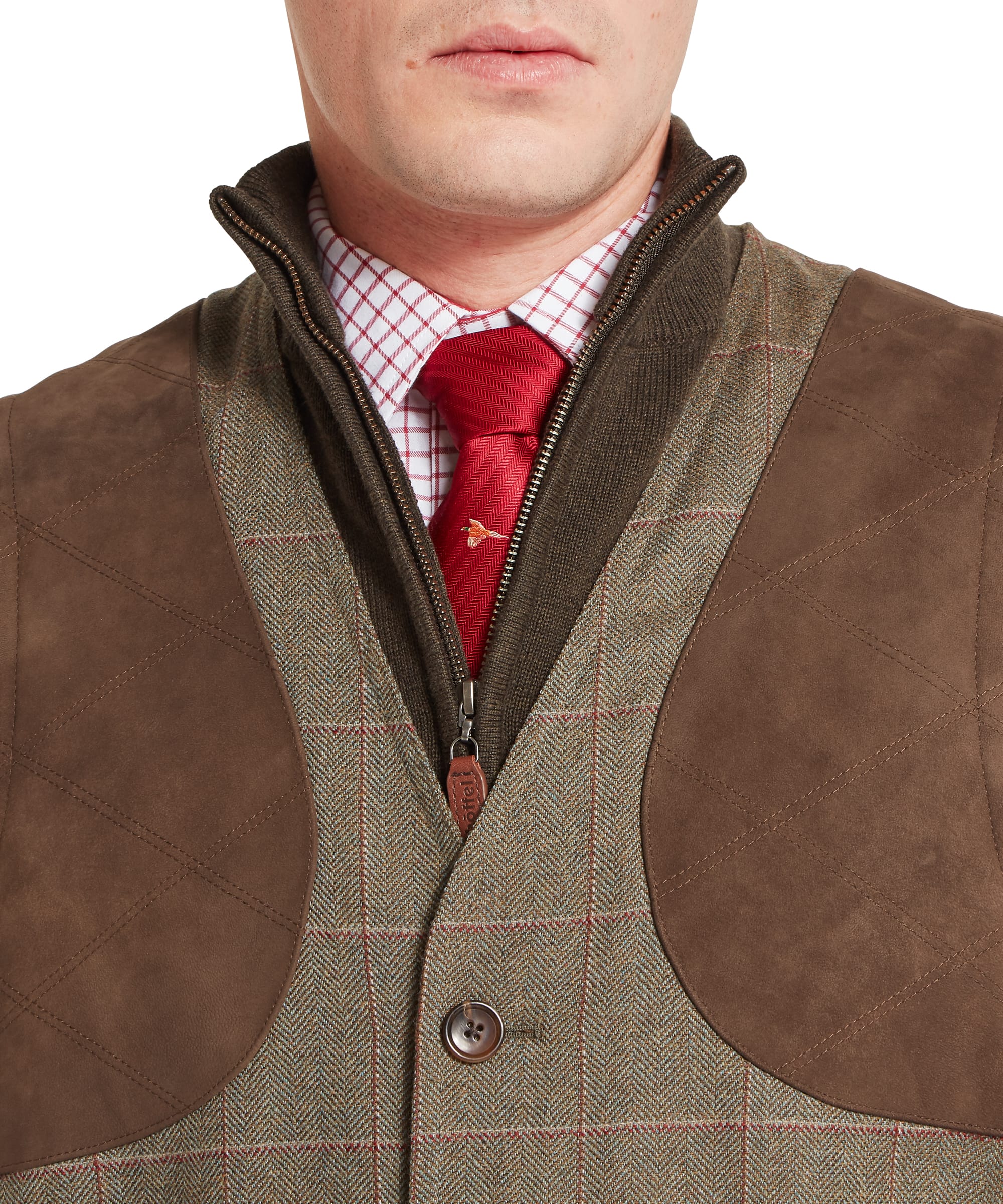 Schöffel Men's Ptarmigan Tweed Waistcoat II in Lovat brown windowpane check — full-length lifestyle shot showing the waistcoat as part of a complete tweed shooting outfit, worn with matching tweed plus twos, red sock garters, country walking boots, a checked shirt, red tie and tweed flat cap