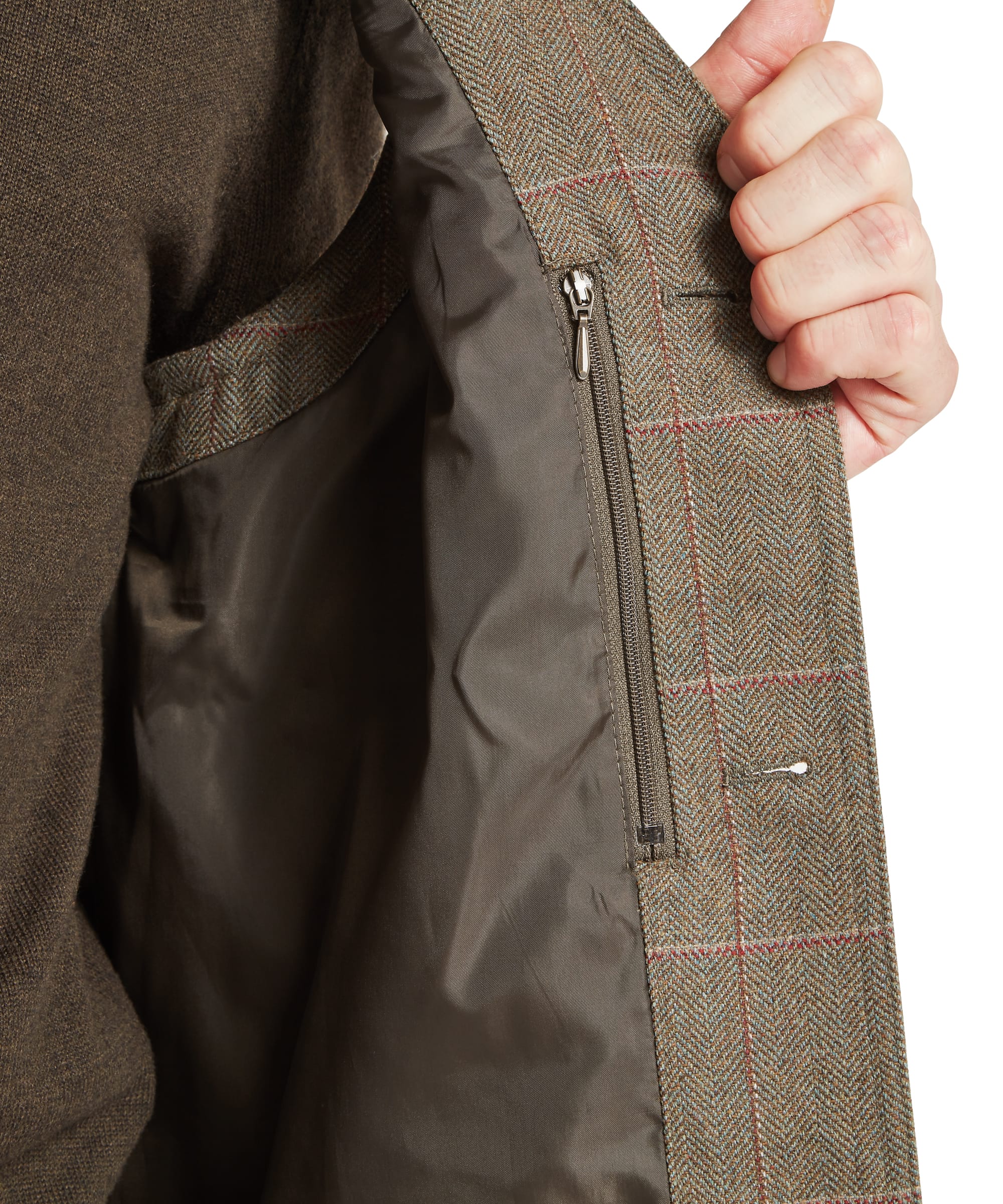 Schöffel Men's Ptarmigan Tweed Waistcoat II in Lovat brown windowpane check — interior close-up showing the zipped internal security pocket with brown lining and Lovat Tweed "Woven in Scotland" heritage label, coat held open by hand