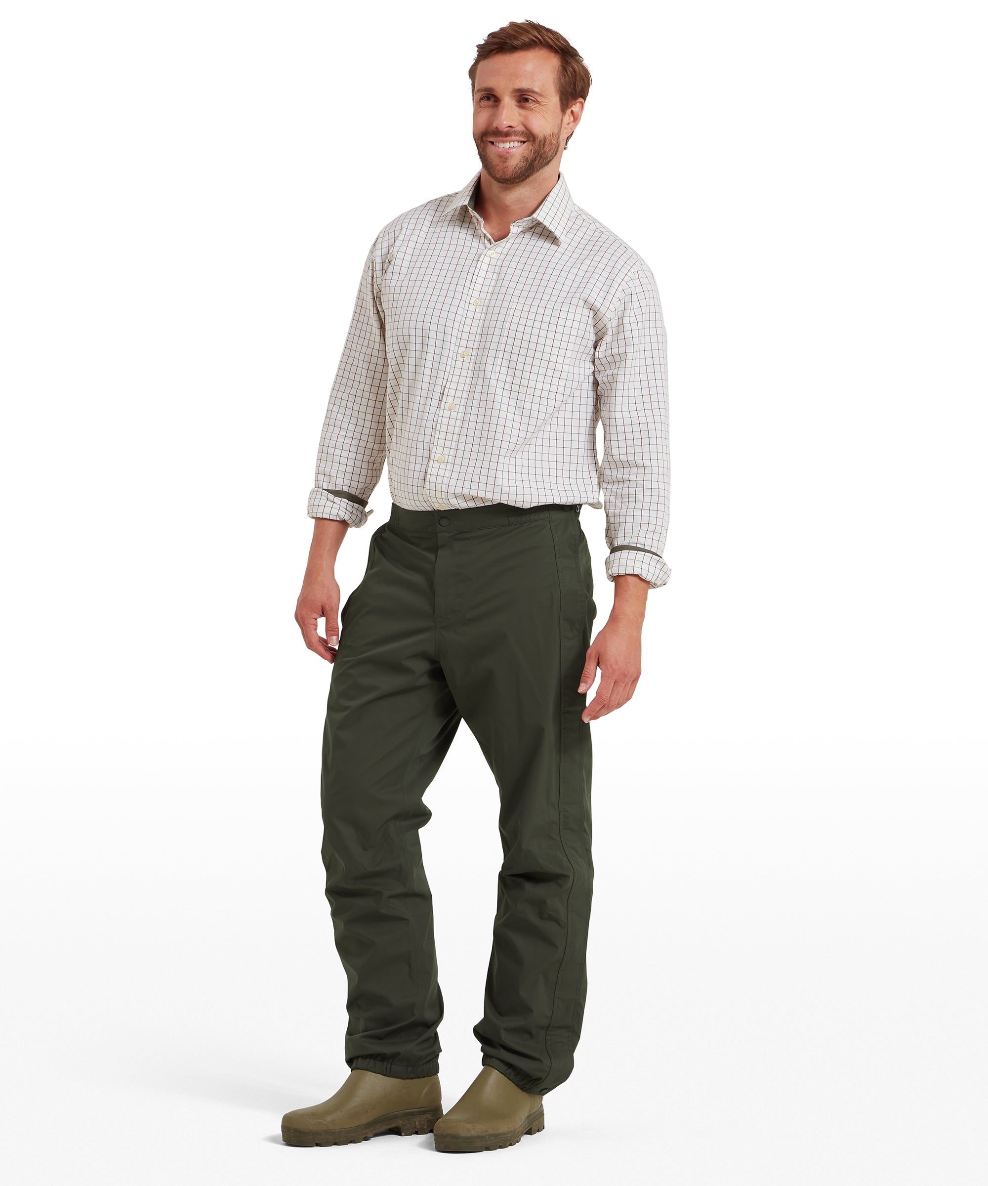 Schöffel Saxby men's overtrousers in green, full-length front view worn with wellington boots, showing straight fit