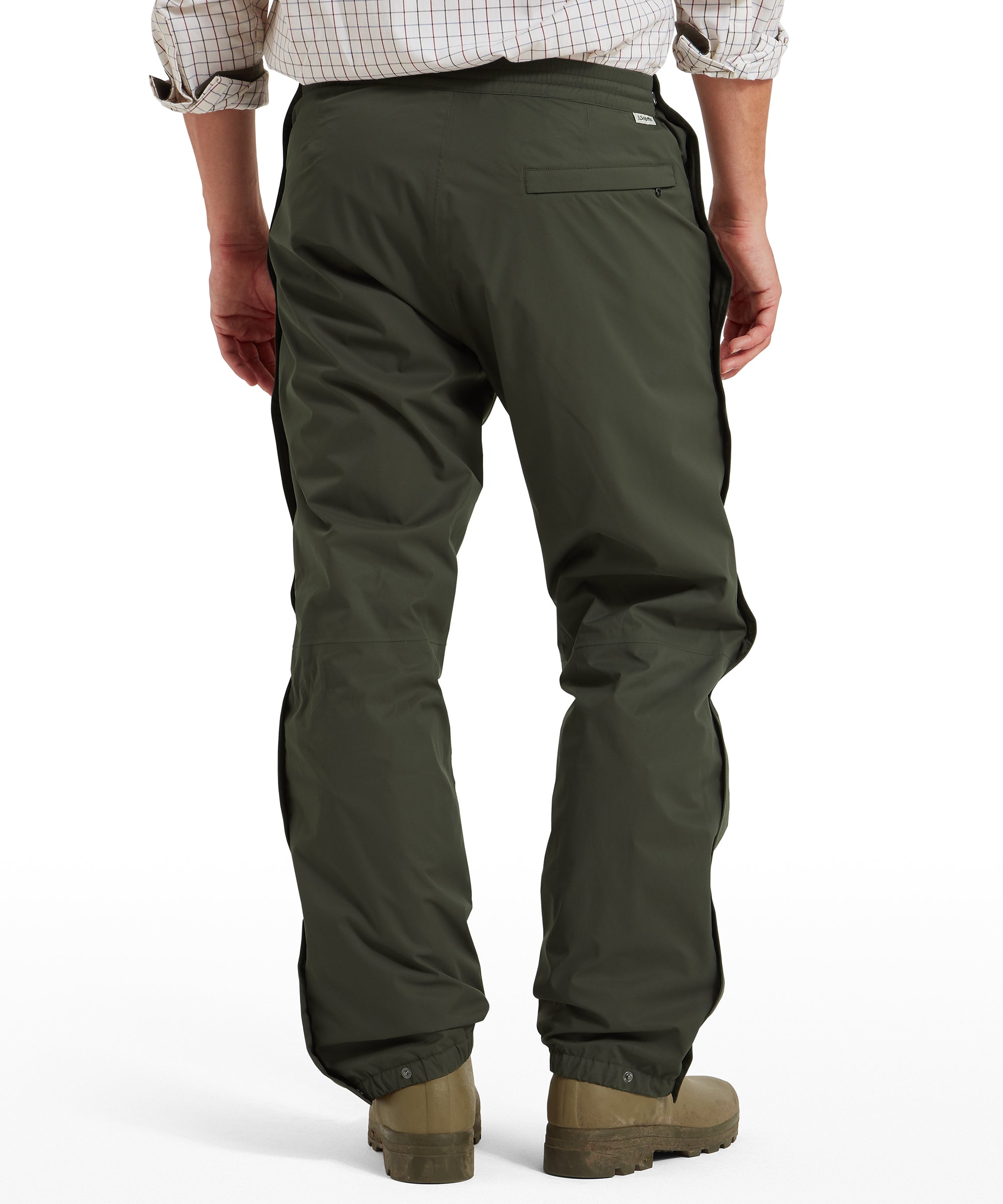 Rear view of Schöffel Saxby men's overtrousers in green, full-length front view worn with wellington boots