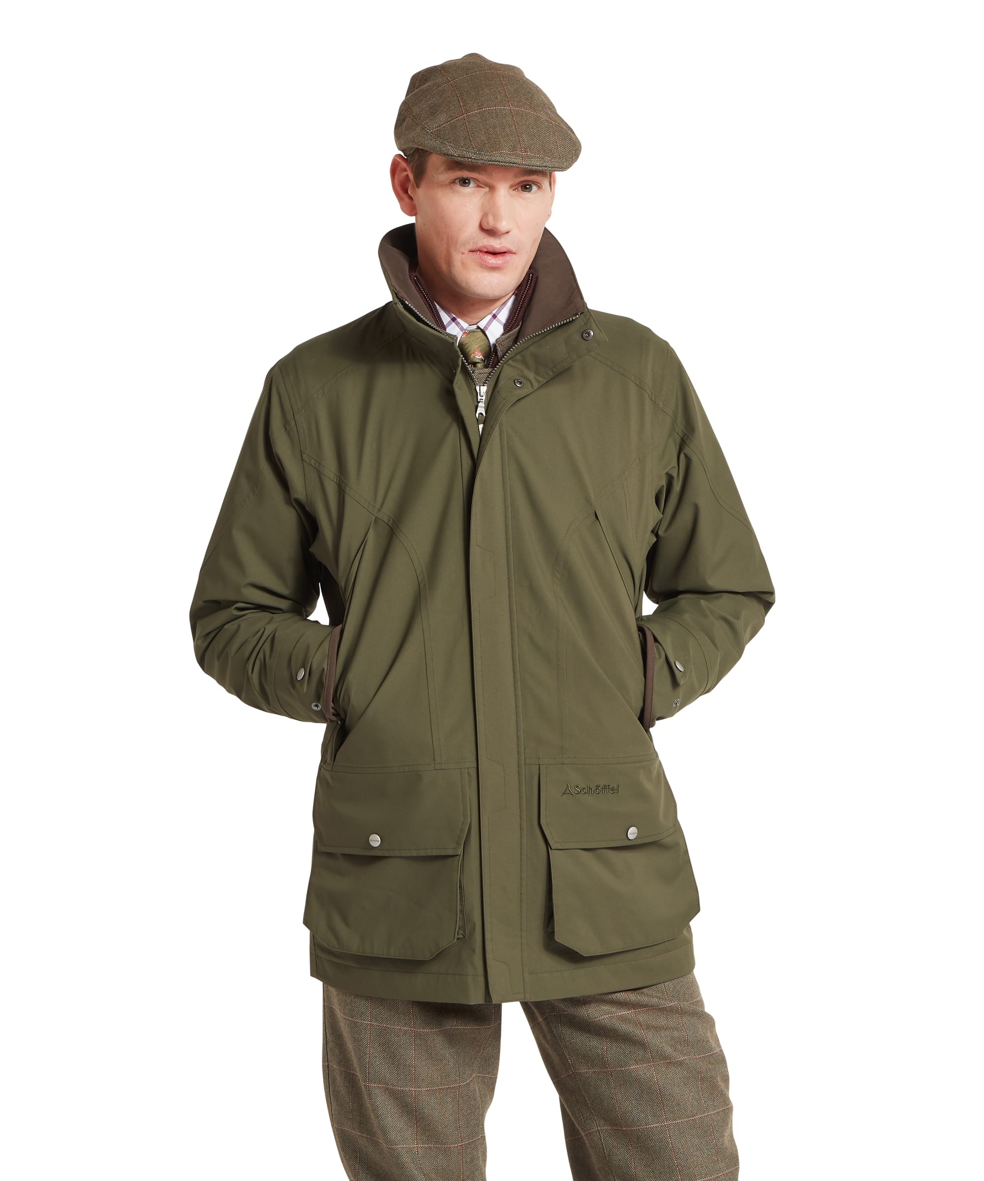 Schöffel Men's Snipe Ultralight Coat in dark olive green — front three-quarter view showing lightweight technical fabric, stand collar with brown fleece lining, Schöffel chest logo, large lower bellows pockets with press-stud flaps and brown grosgrain binding on the cuffs, worn with tweed plus twos and a tweed flat cap