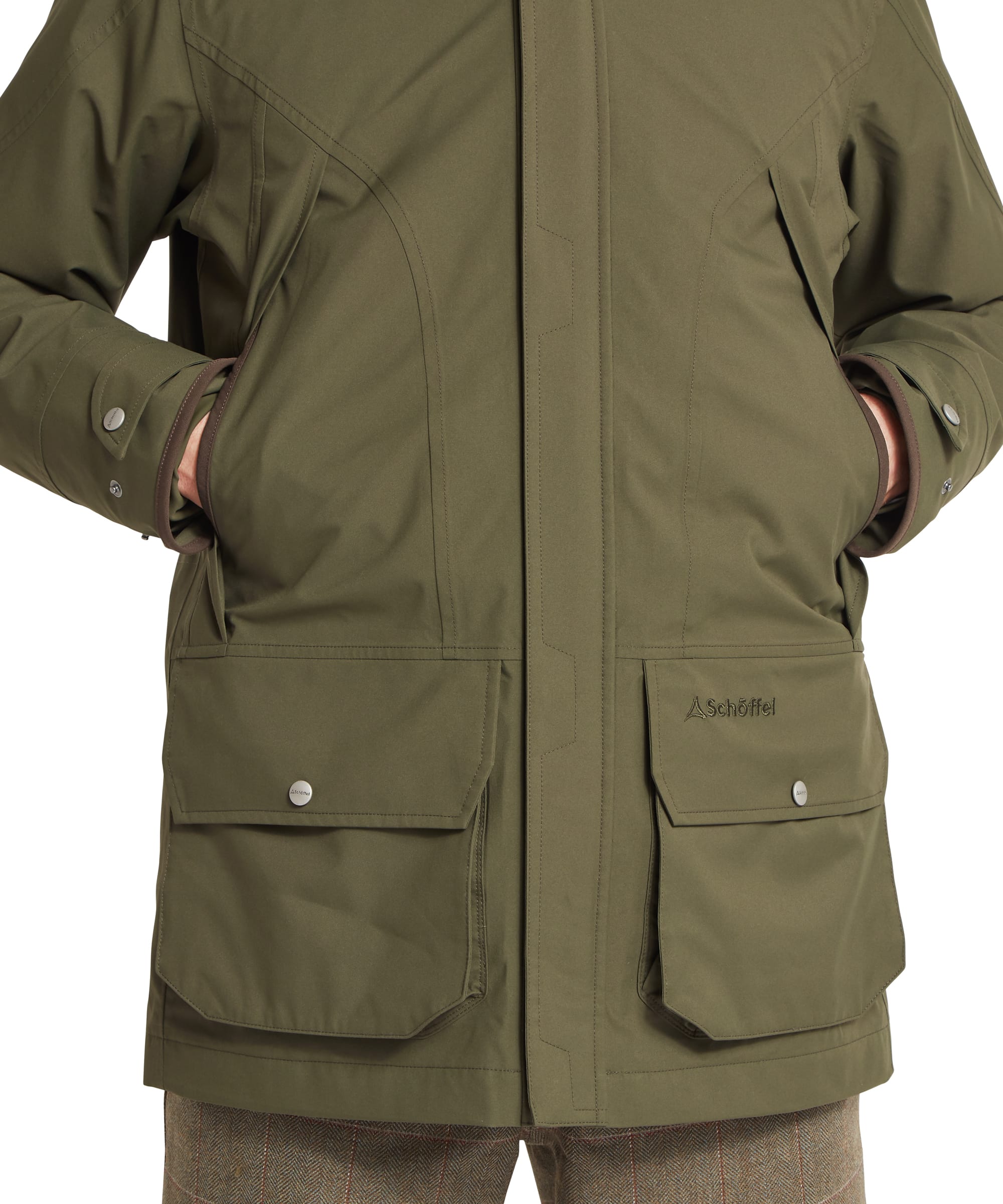 Schöffel Men's Snipe Ultralight Coat in dark olive green — close-up of the large lower bellows pocket with brown grosgrain binding on the handwarmer opening, press-stud flap and Schöffel woven label, hand inside the pocket