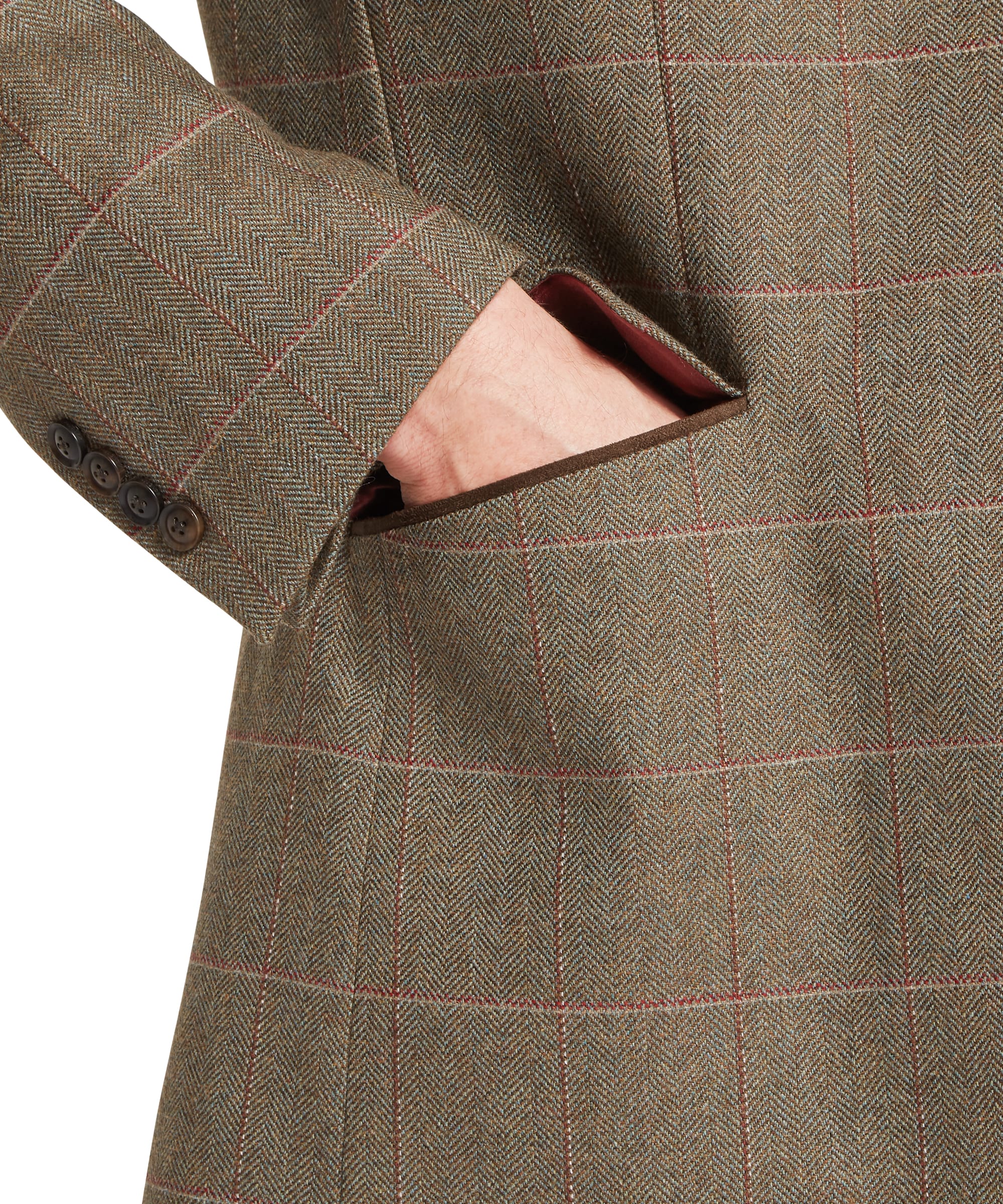 Schöffel Men's St Andrews Tweed Sports Jacket in Lovat brown Lochlane windowpane check — close-up of the lower pocket area showing suede-bound jetted pocket opening with red and buff overcheck fabric and three-button cuff detail