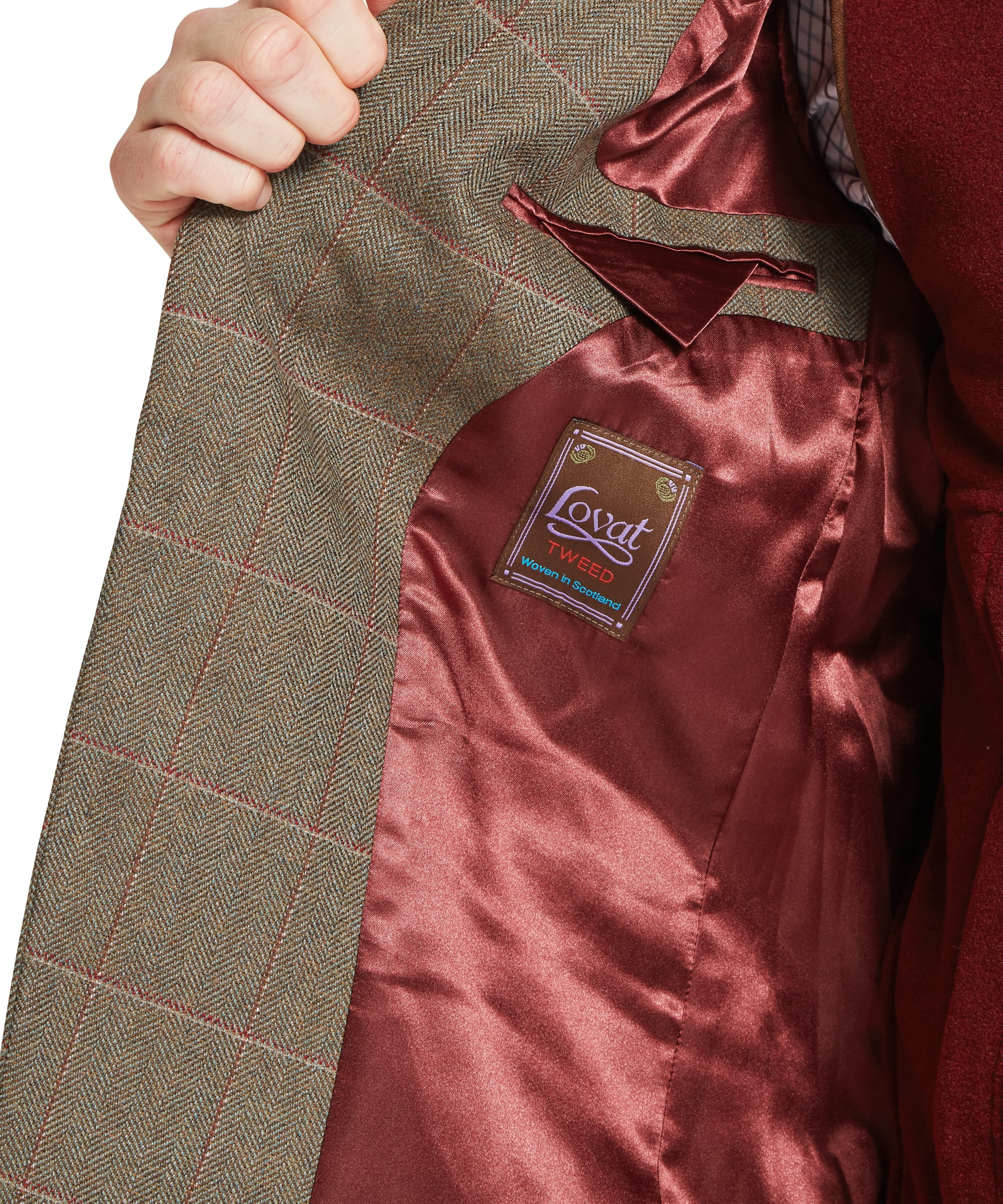Schöffel Men's St Andrews Tweed Sports Jacket in Lovat brown Lochlane windowpane check — interior detail showing the rich burgundy satin lining, internal welt pocket and Lovat Tweed "Woven in Scotland" heritage label, coat held open by hand