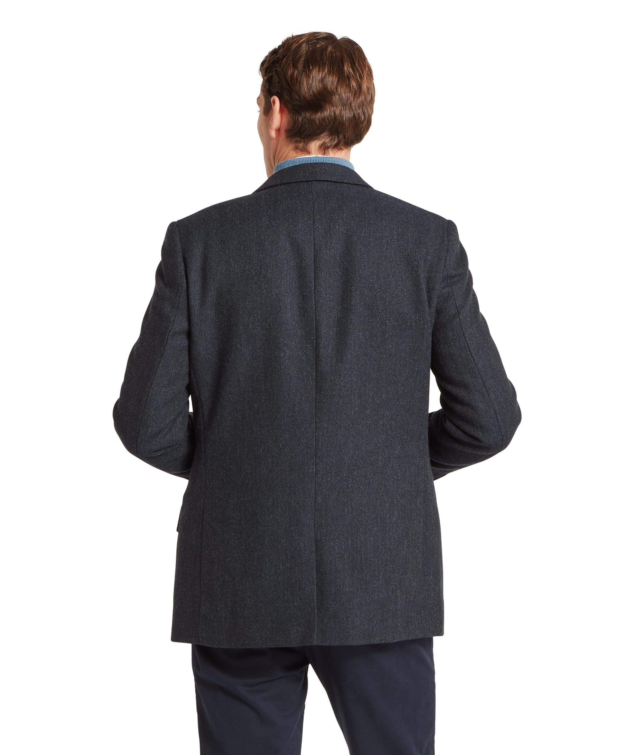 Schöffel Men's St Andrews Tweed Sports Jacket in navy herringbone — close-up of the chest area showing the notched lapel, suede-bound jetted chest pocket and layered styling over a light blue zip-neck merino gilet with Schöffel branded leather zip pull and checked shirt