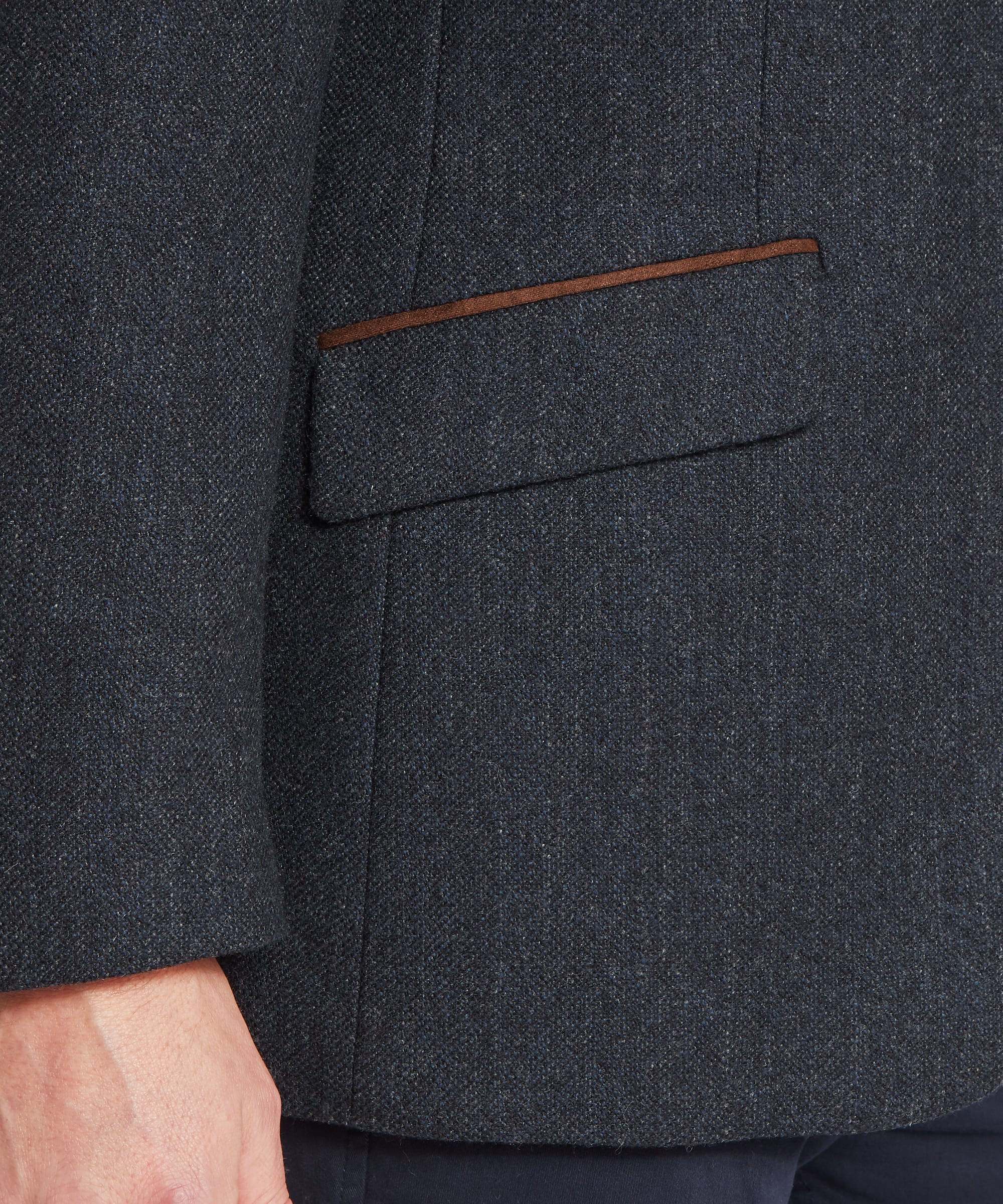 Schöffel Men's St Andrews Tweed Sports Jacket in navy herringbone — close-up of the lower flap pocket with brown suede binding trim, showing the dark navy herringbone Lovat Tweed texture in detail