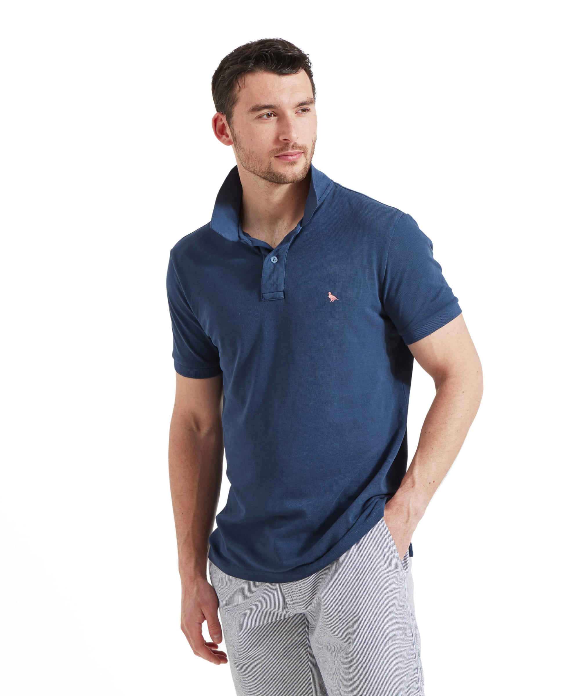 Schöffel Men's St Ives Garment Dyed Polo Shirt in denim blue, worn by model styled with striped shorts and sandals