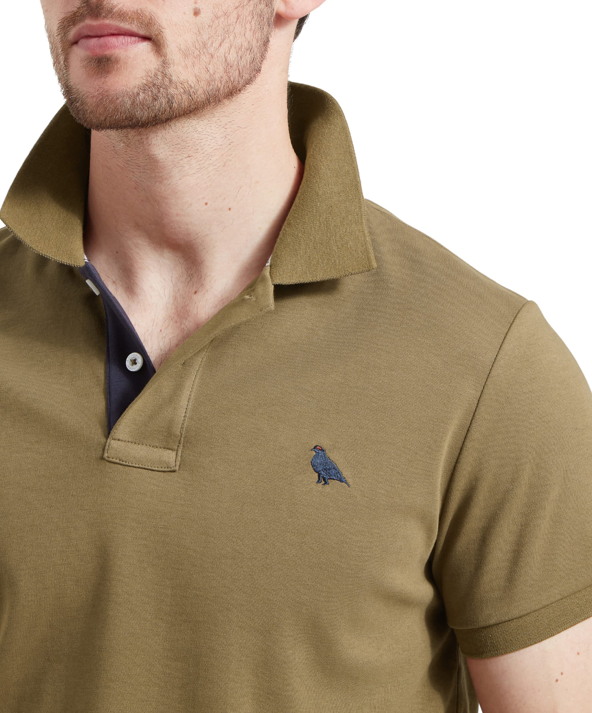 Schöffel Men's St Ives Jersey Polo Shirt in olive green, close-up collar and placket detail on model showing embroidered grouse motif