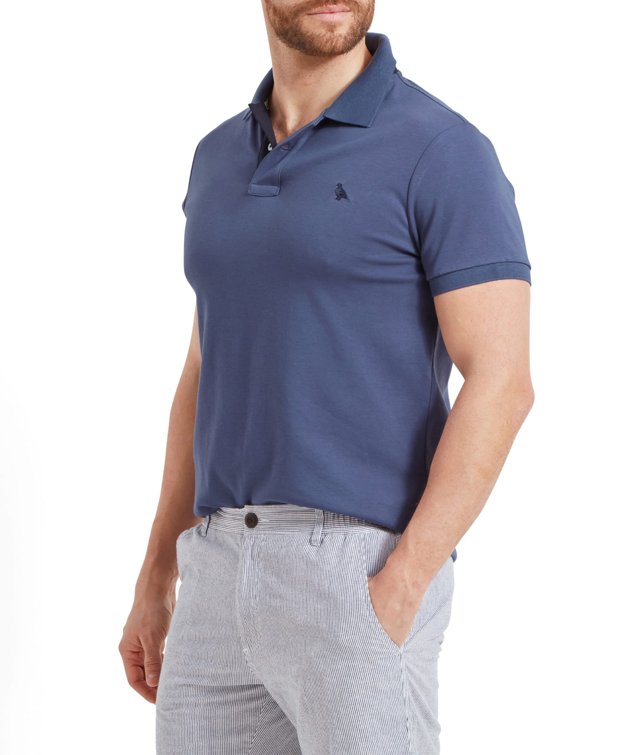 Schöffel Men's St Ives Jersey Polo Shirt in slate blue, side profile on model styled with striped shorts