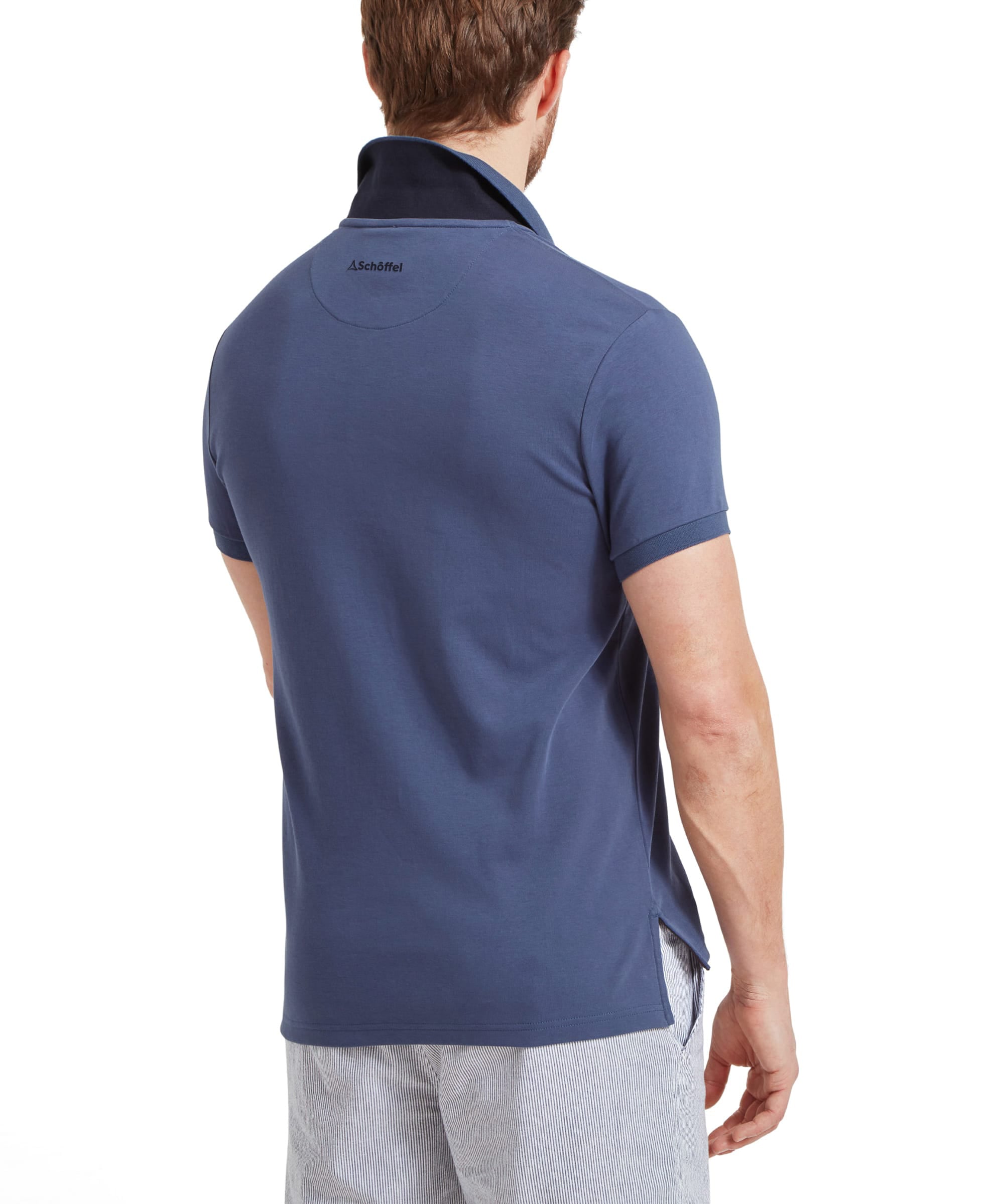 Schöffel Men's St Ives Jersey Polo Shirt in slate blue, back view on model showing Schöffel neck branding, styled with striped shorts