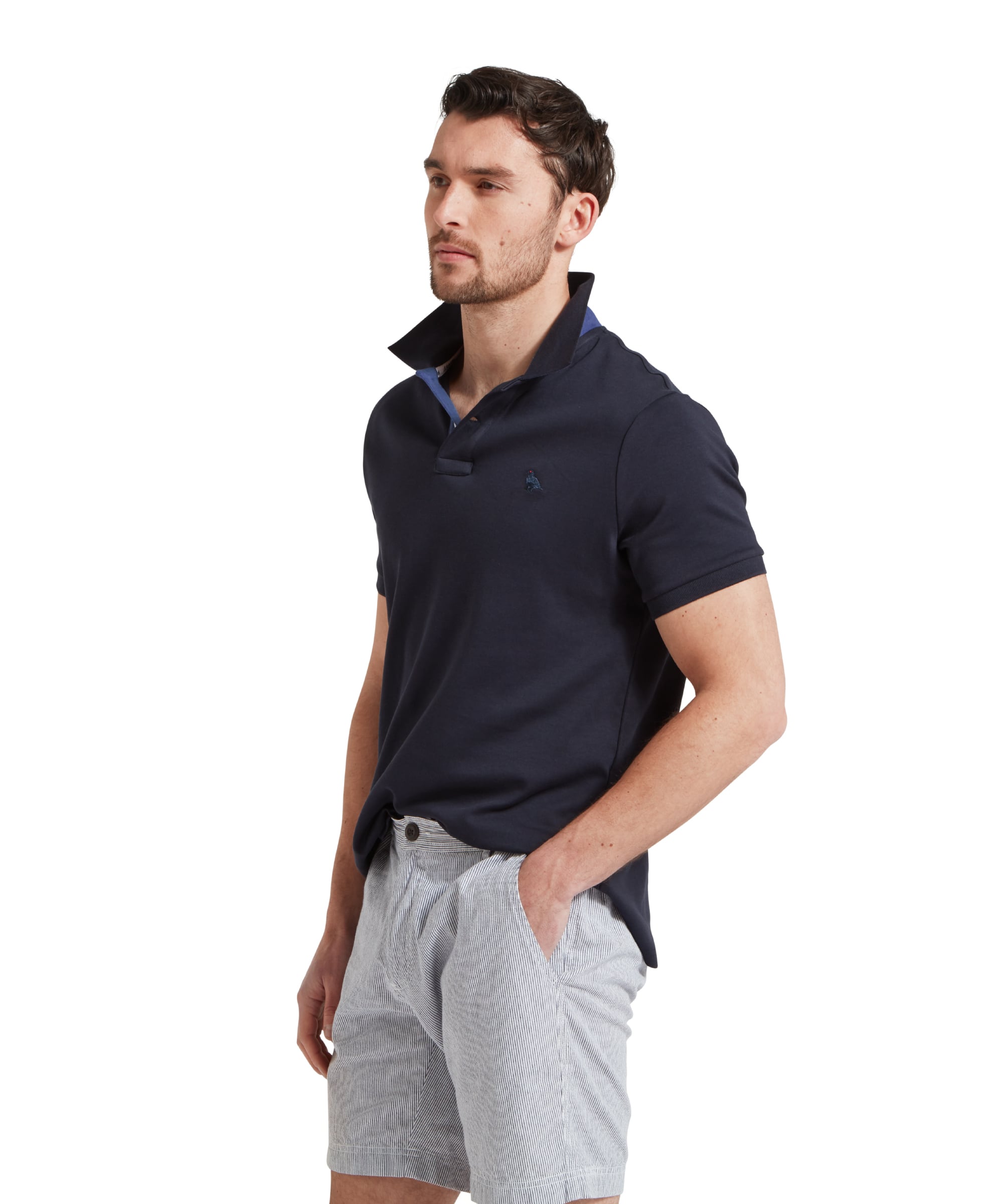 Schöffel Men's St Ives Jersey Polo Shirt in navy, side profile on model styled with striped shorts