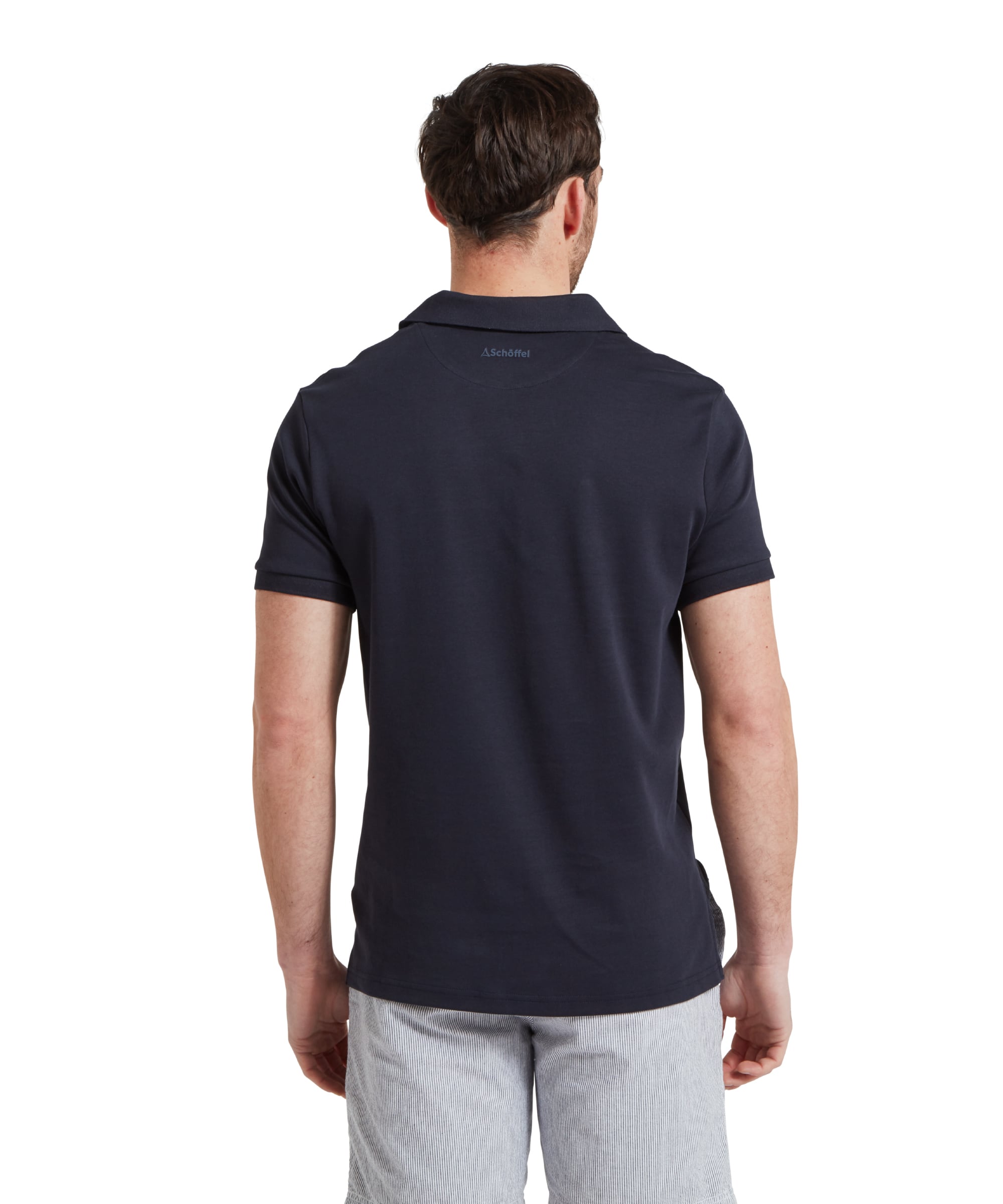 Schöffel Men's St Ives Jersey Polo Shirt in navy, back view on model showing Schöffel neck branding, styled with striped shorts