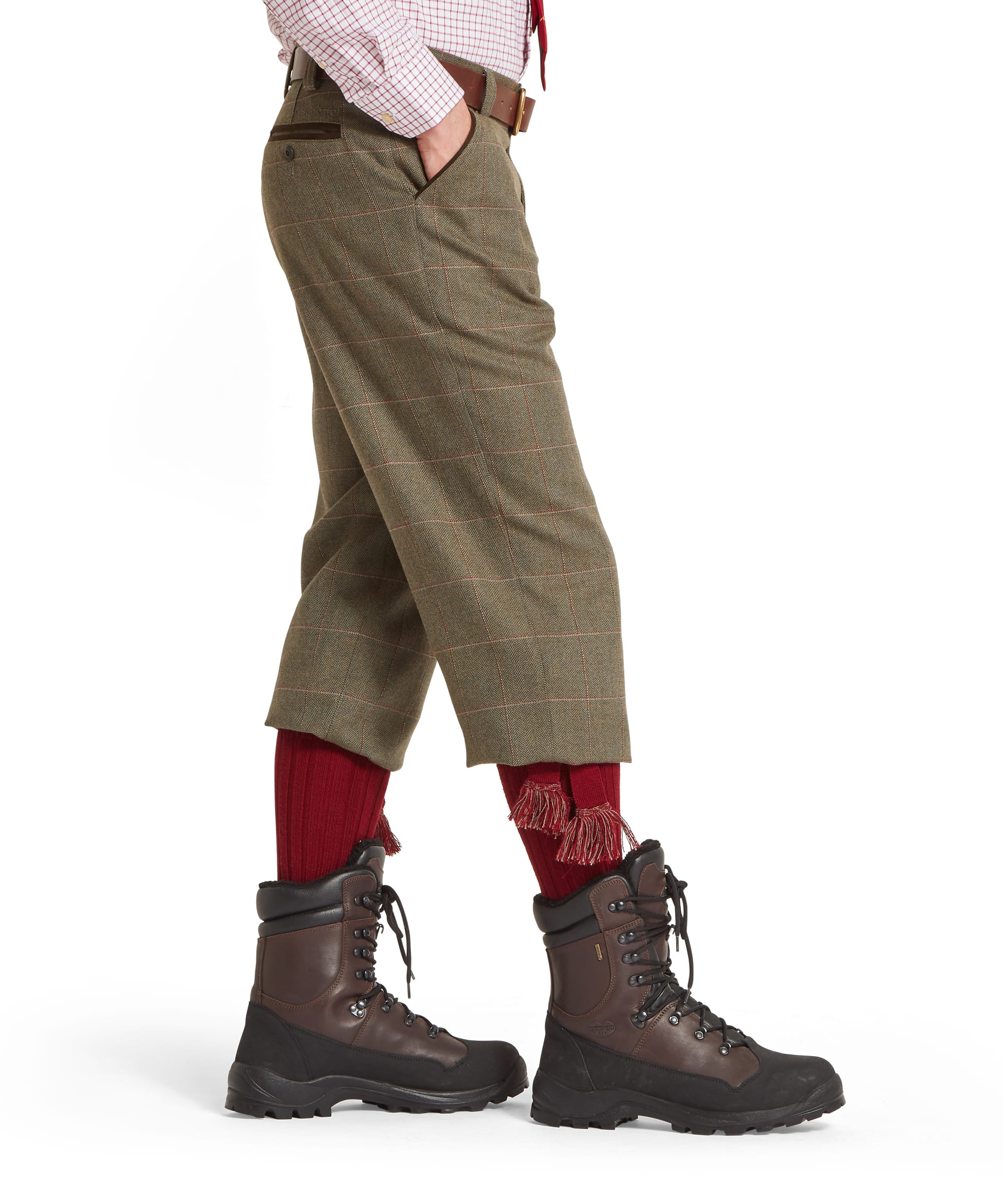 Schöffel Lochlane tweed plus fours in sage green herringbone with red windowpane check — side view showing below-the-knee length, leather belt and side pocket, styled with red wool shooting socks and brown leather country boots
