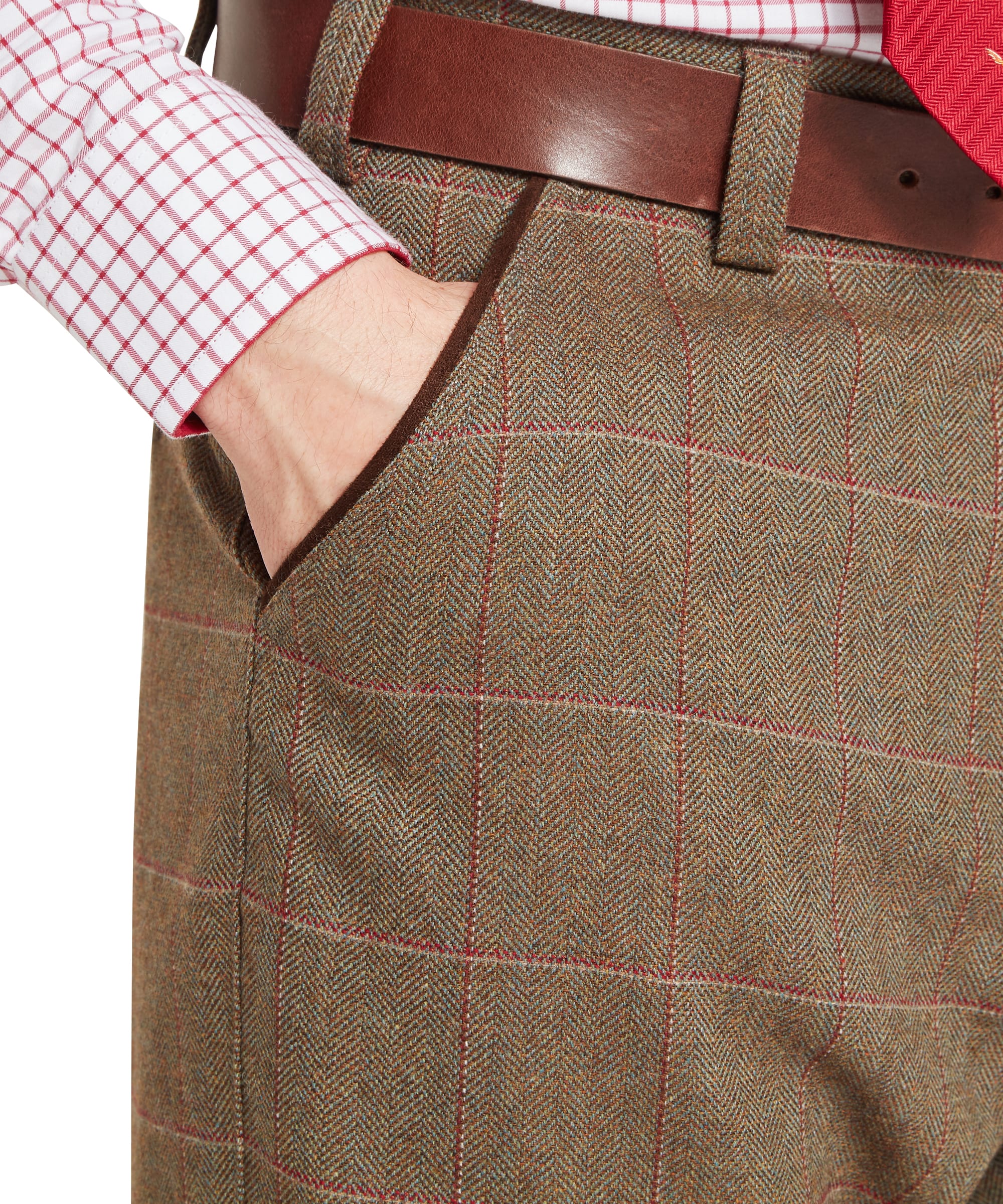 Schöffel Lochlane tweed plus fours in sage green herringbone with red windowpane check — close up pocket view showing velvet-trimmed  pocket and brown leather belt