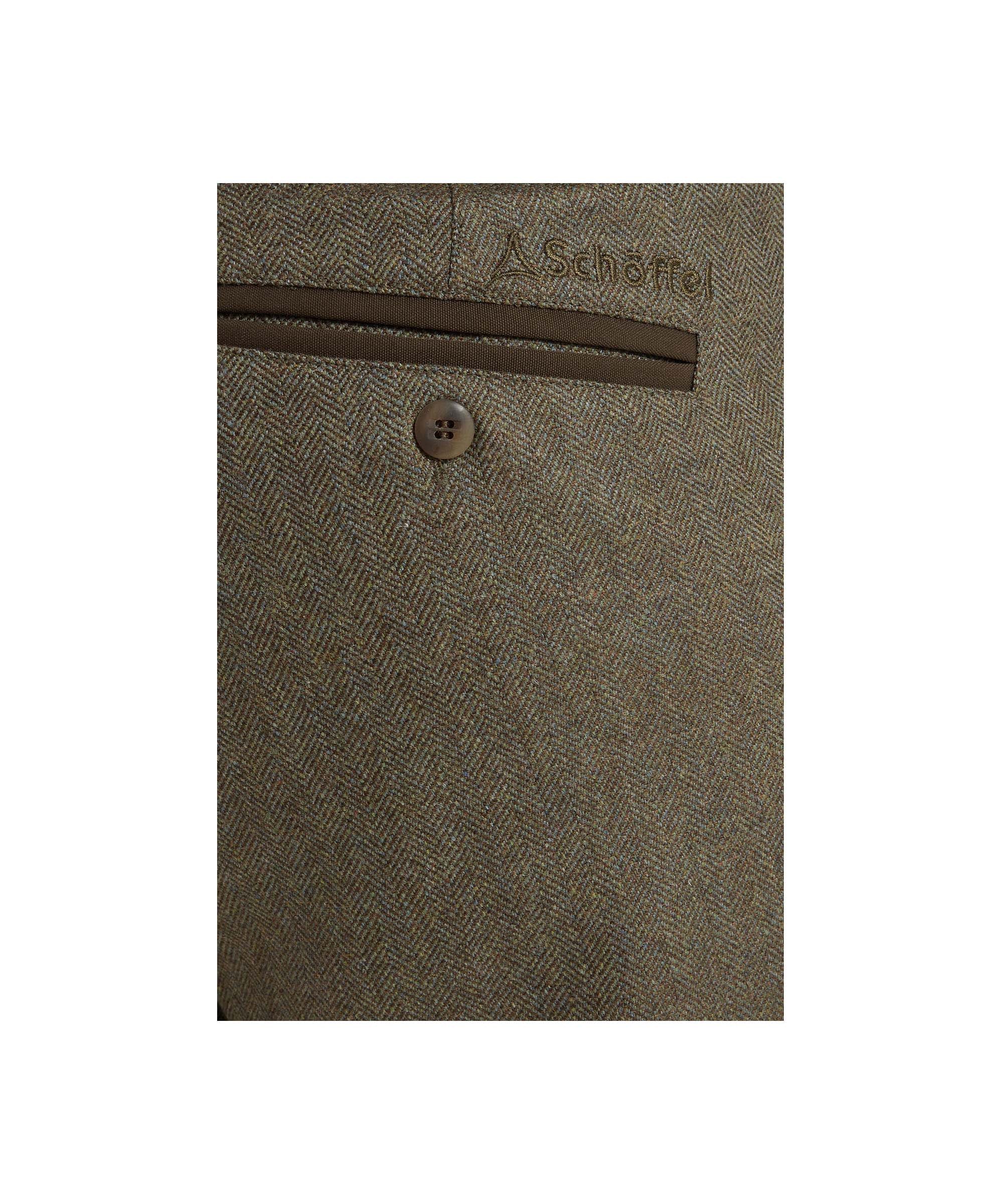 Schöffel Men's Tweed Plus Twos in Green herringbone tweed worn by male model, rear close-up showing back pocket and branded embroidered logo detail