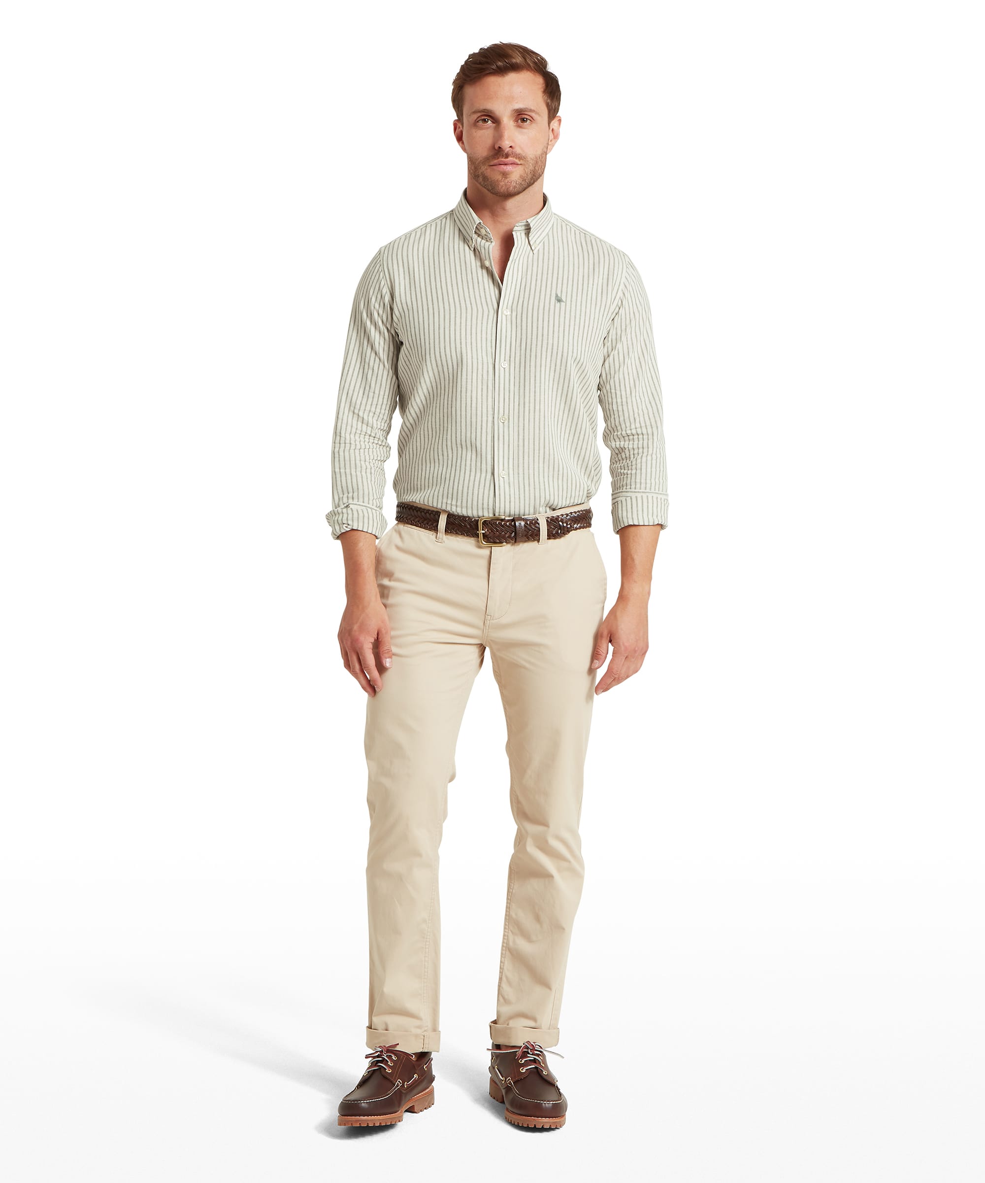 Man wearing Schöffel green and white striped long-sleeve button-down shirt with stone chino trousers and brown leather boat shoes
