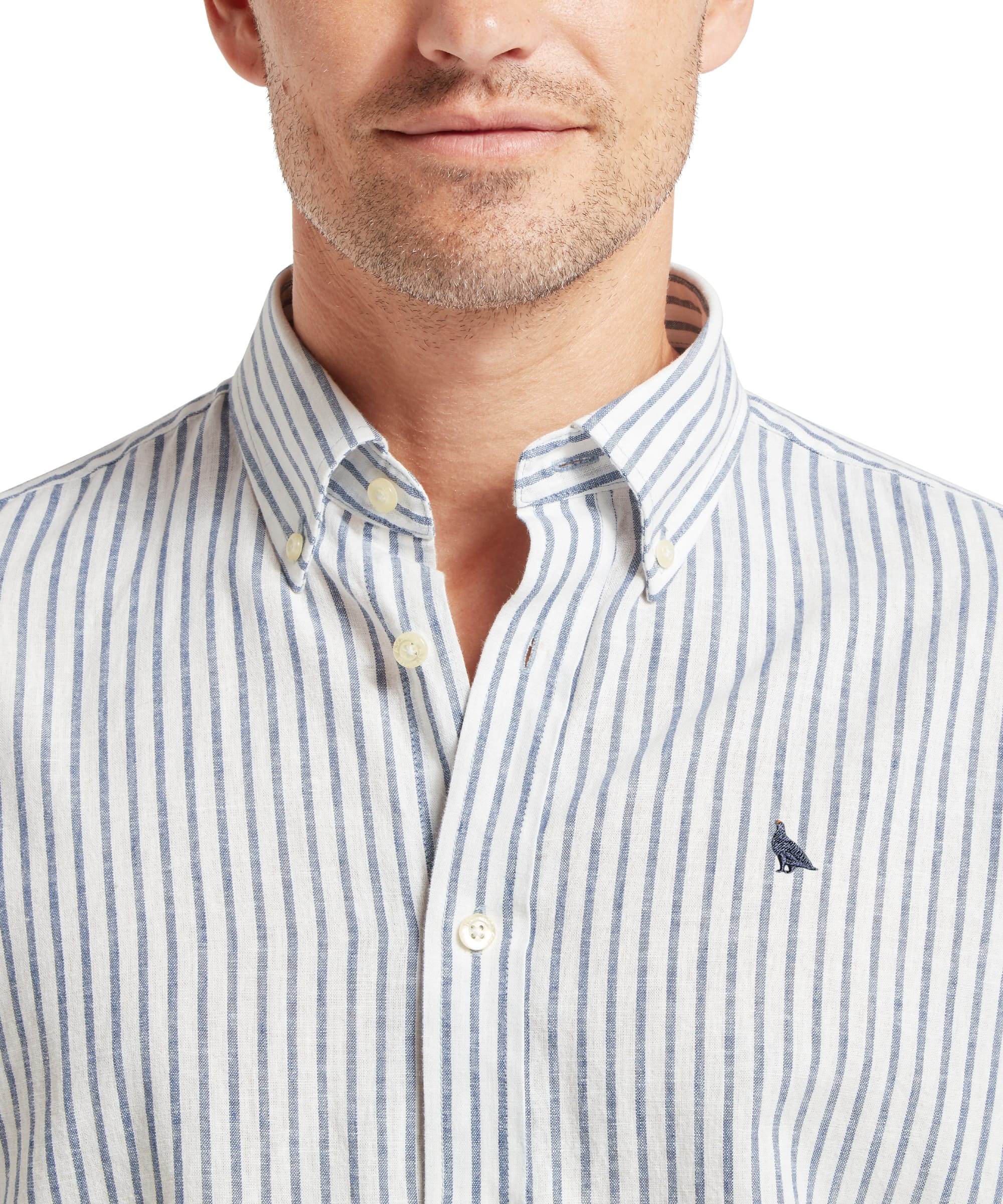 Close-up of Schöffel Men's Walsingham Linen Shirt in blue stripe showing button-down collar, cream buttons and embroidered pheasant logo