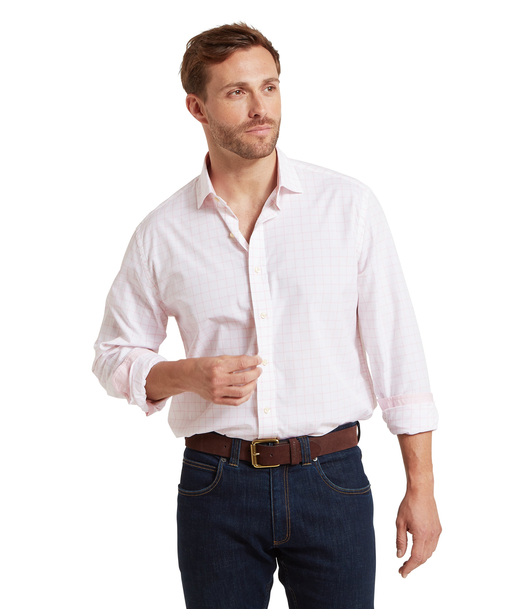 Man wearing a white and pink checked shirt and dark jeans on a white background