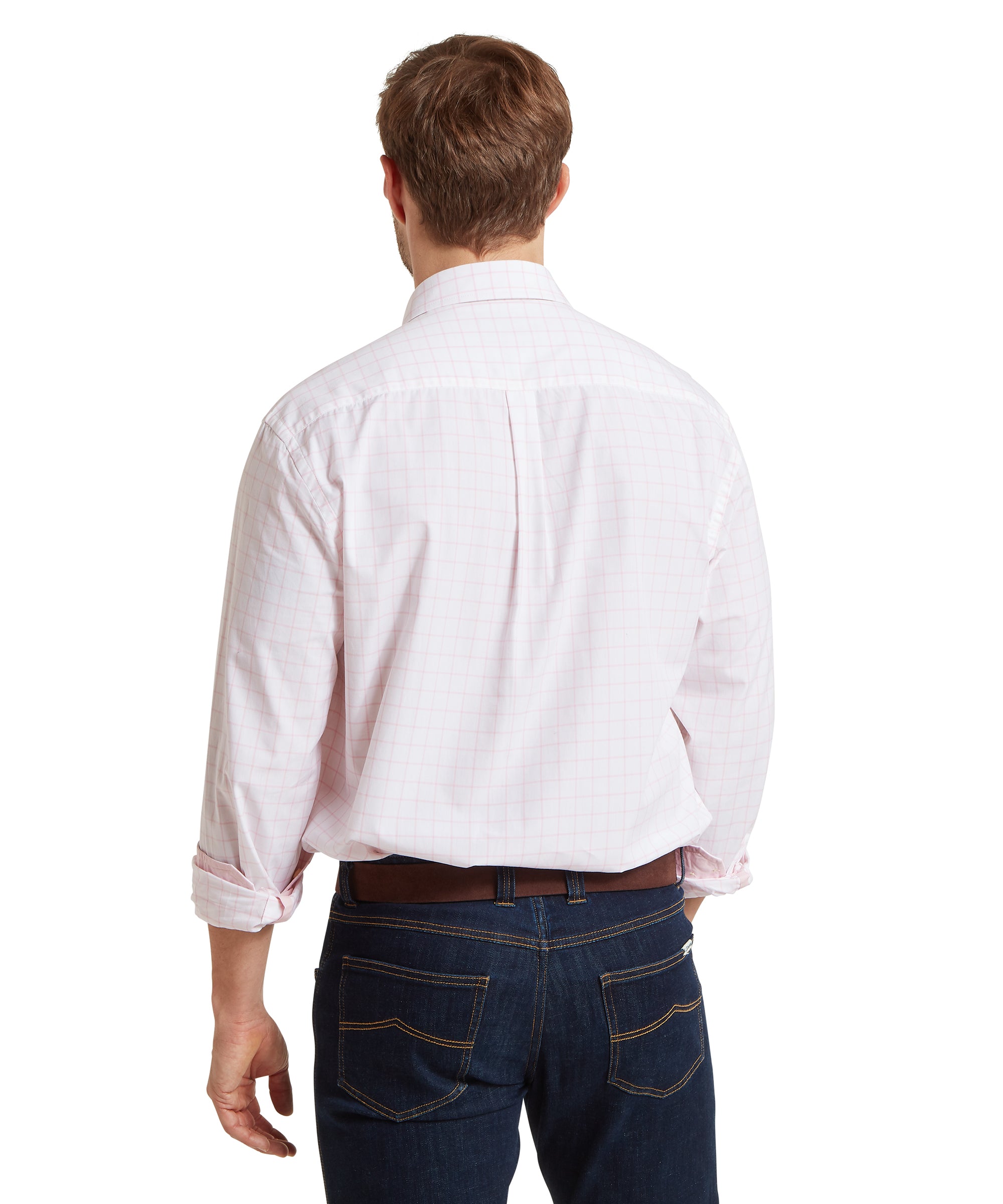 Man wearing a white and pink checked shirt and dark jeans on a white background