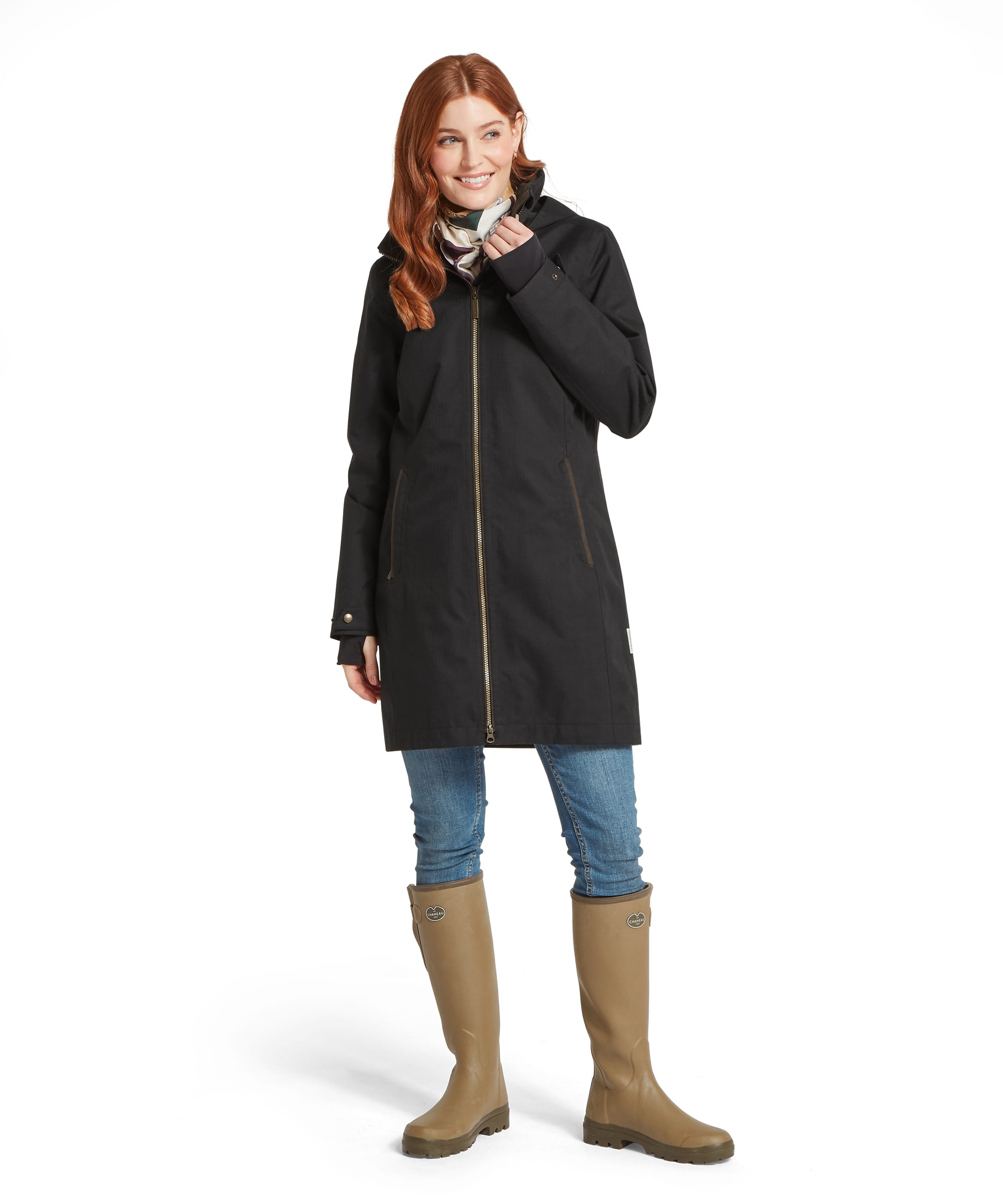 Schöffel Women's Allexton Waterproof Coat in Black — styled with skinny jeans and khaki wellington boots, hood raised