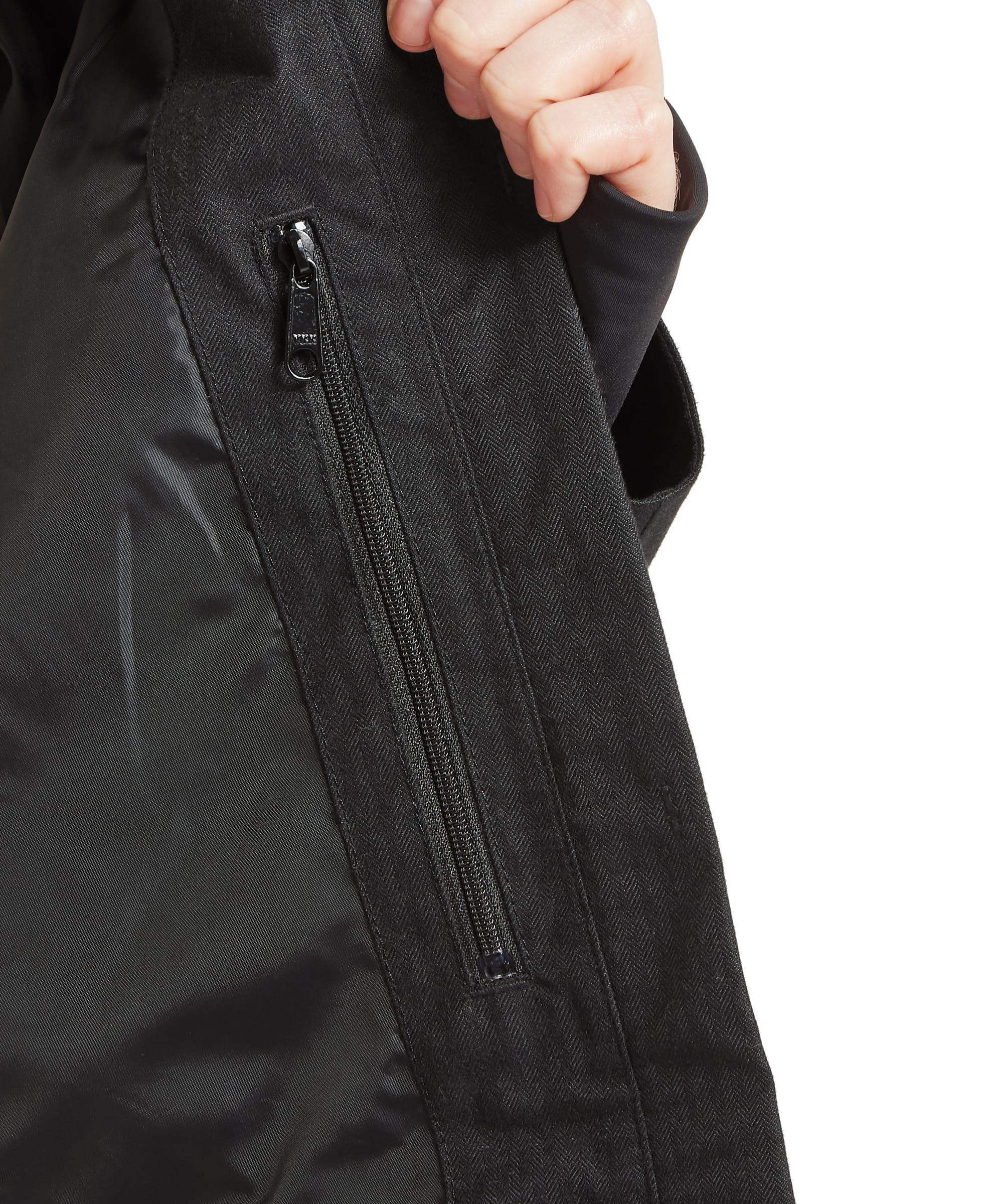 Close-up of the zipped side pocket and ribbed inner cuff on the Schöffel Women's Allexton Waterproof Coat in Charcoal Herringbone, showing the interior lining and practical zip pocket construction