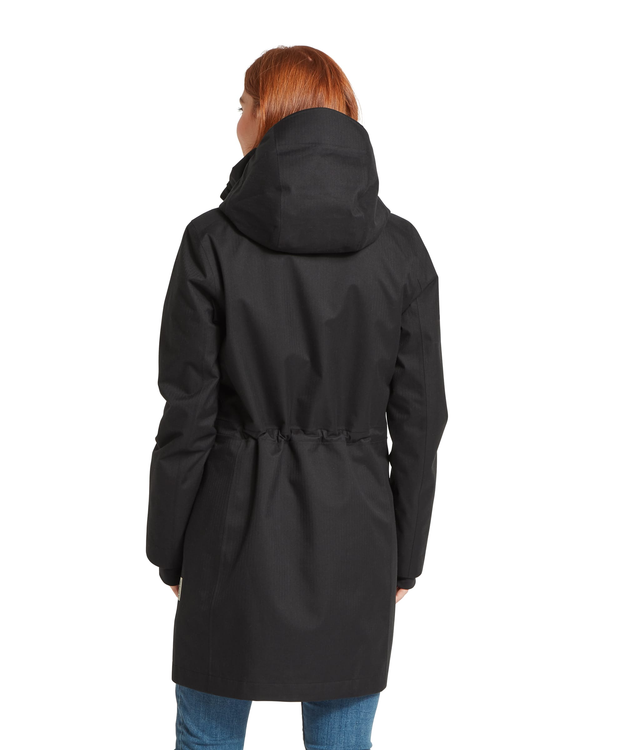 Rear view of the Women's Schöffel Allexton Waterproof Coat in charcoal grey, showing the drawcord waist adjustment, structured hood and mid-length cut, worn with blue jeans.