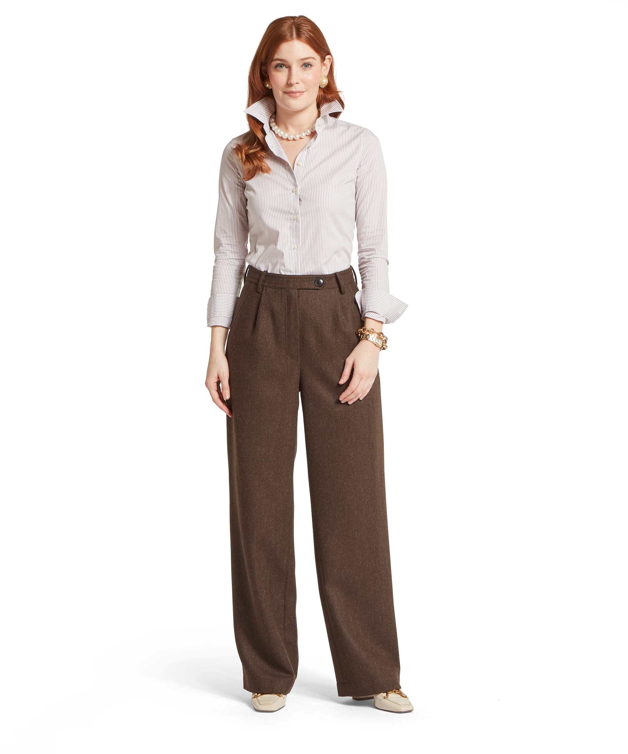Full-length view of the Women's Schöffel Arabella Tweed Trouser in brown herringbone tweed, with a flattering high-waist wide-leg cut, paired with a fitted pinstripe shirt, pearl necklace and cream horsebit loafers.