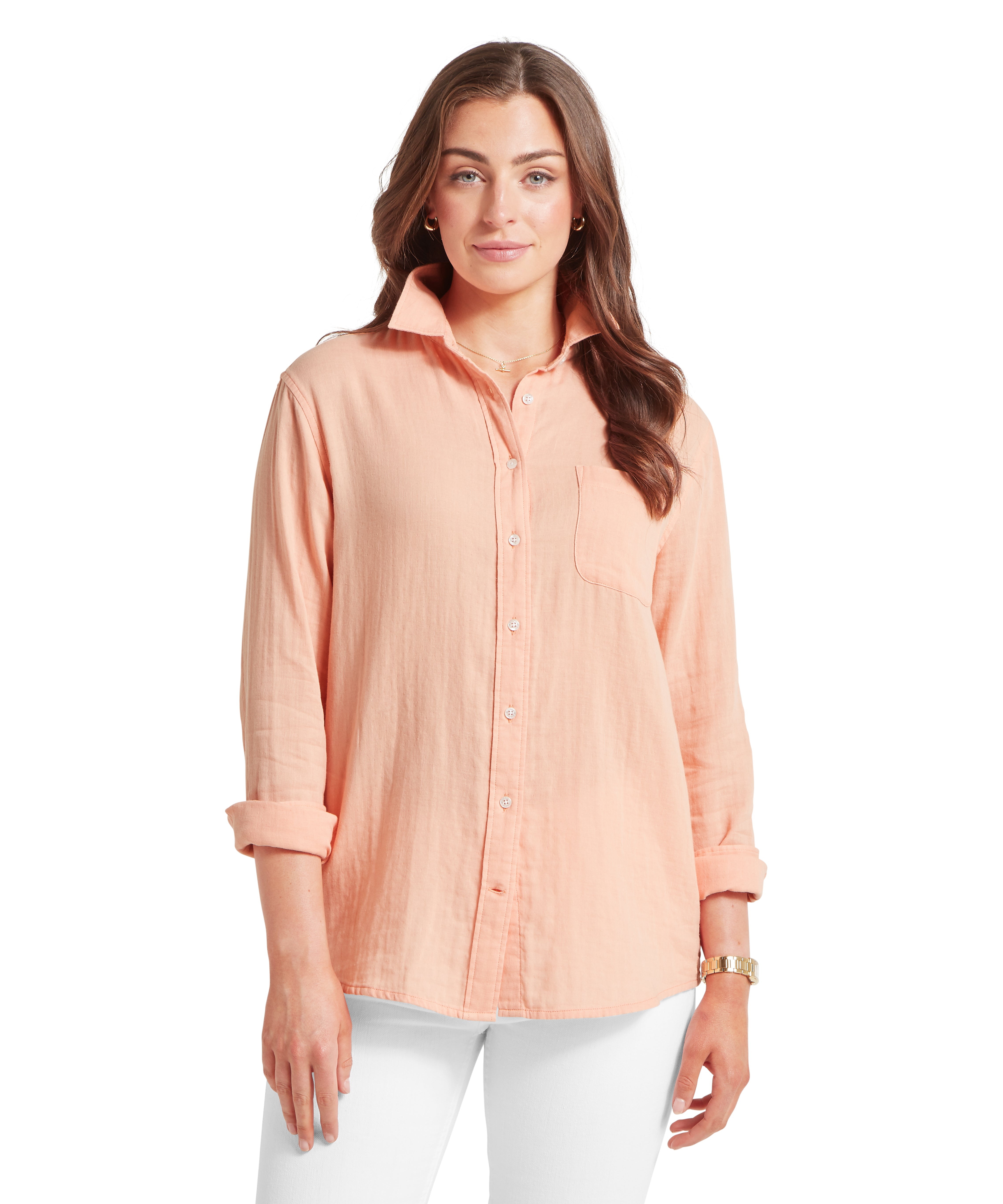 Woman wearing a peach-coloured button-up shirt on a white background