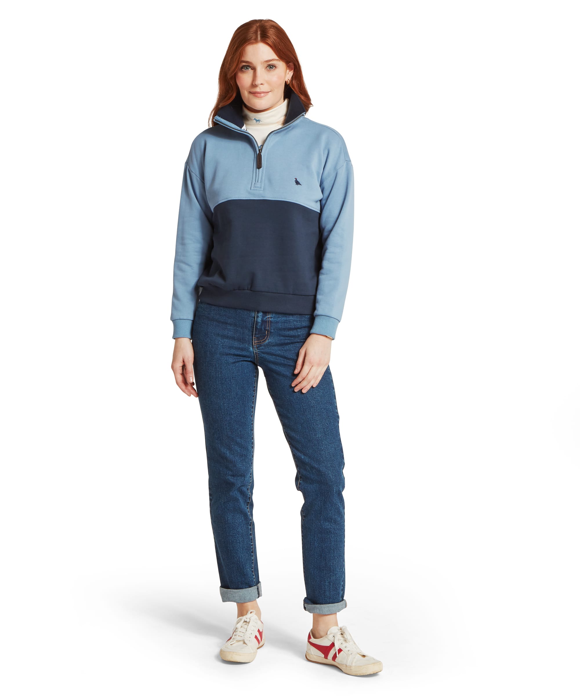 Schöffel Women's Braunton Quarter-Zip Sweatshirt in blue colourblock, full-length front view with light blue and navy two-tone design, ribbed hem and cuffs, and branded Schöffel zip pull, styled with blue denim jeans and white trainers