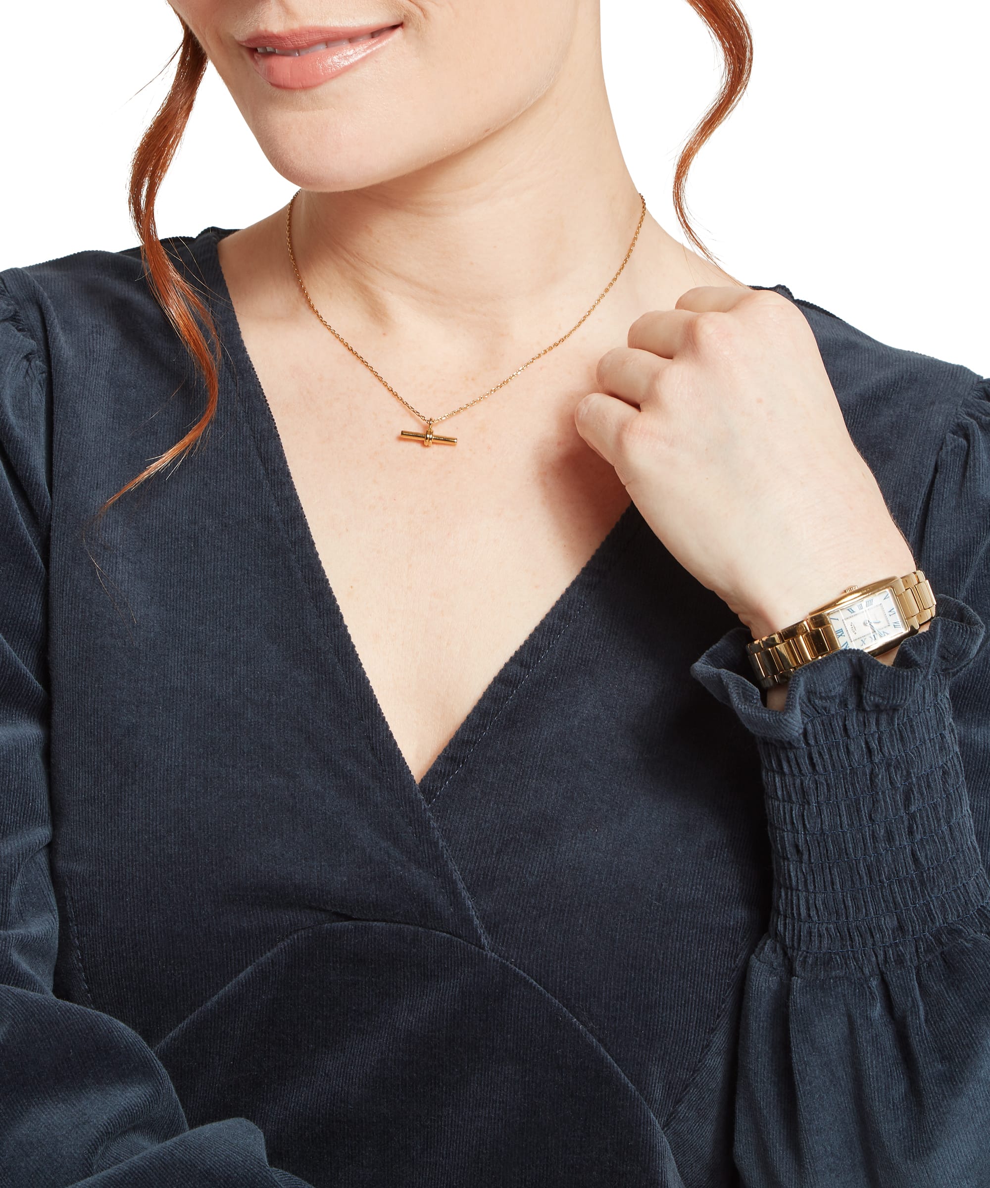 Close-up detail of the Women's Schöffel Briar Cord Dress in navy cord, showing the deep V-neckline with twist detail, shirred smocked cuffs and the fine needlecord fabric texture, accessorised with a gold T-bar necklace.