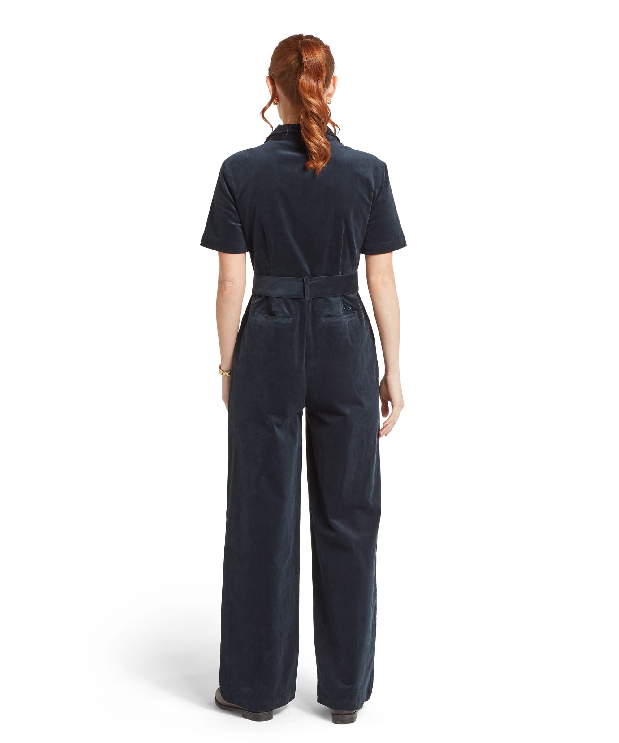 Rear view of the Women's Schöffel Briar Cord Jumpsuit in midnight navy cord, showing the clean back seaming, self-tie waist belt at the back, short sleeves and wide-leg trouser silhouette in fine needlecord.
