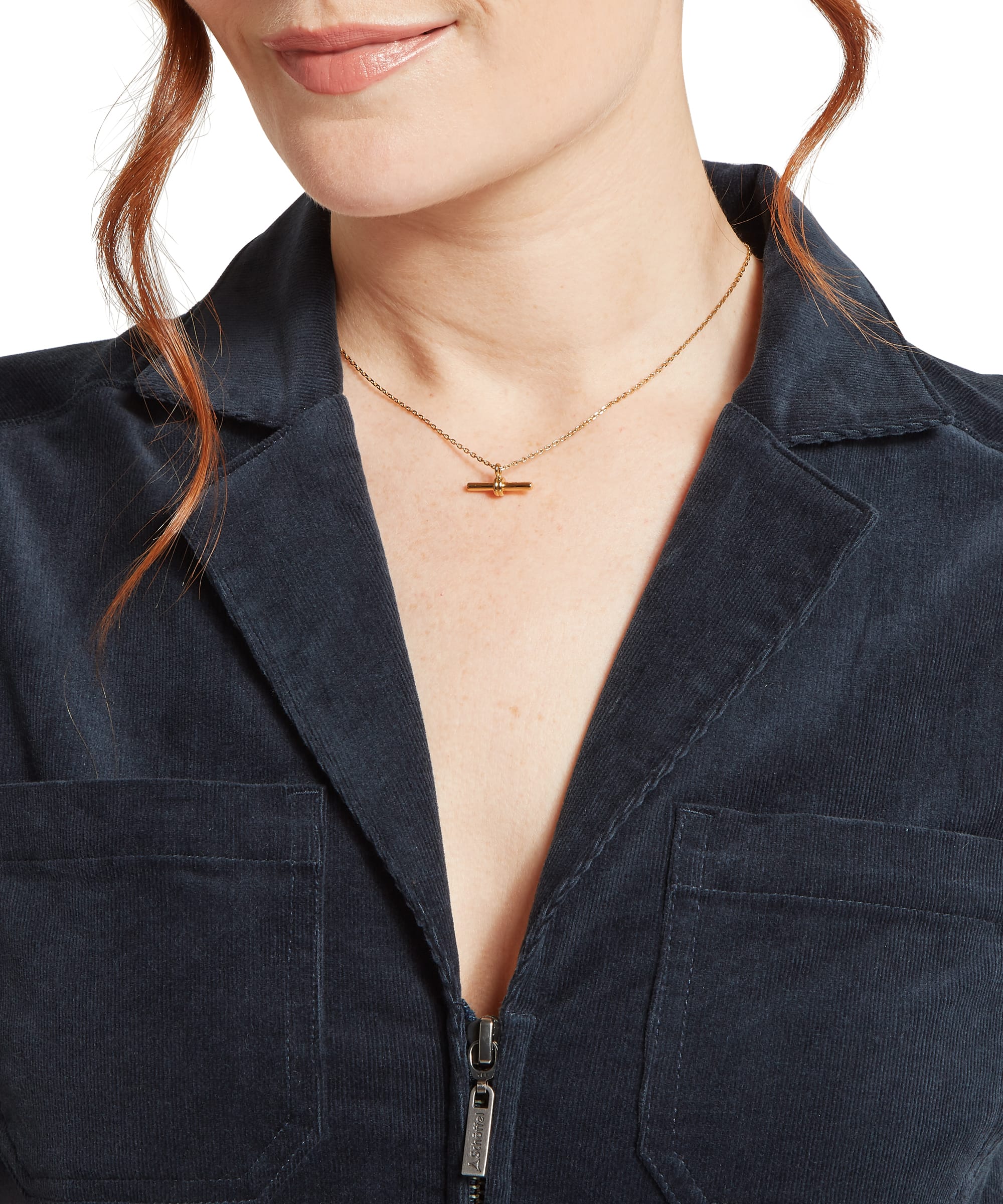 Close-up detail of the Women's Schöffel Briar Cord Jumpsuit in navy needlecord, highlighting the V-neckline with notched lapel collar, Schöffel branded zip pull, chest patch pocket and fine cord fabric texture.