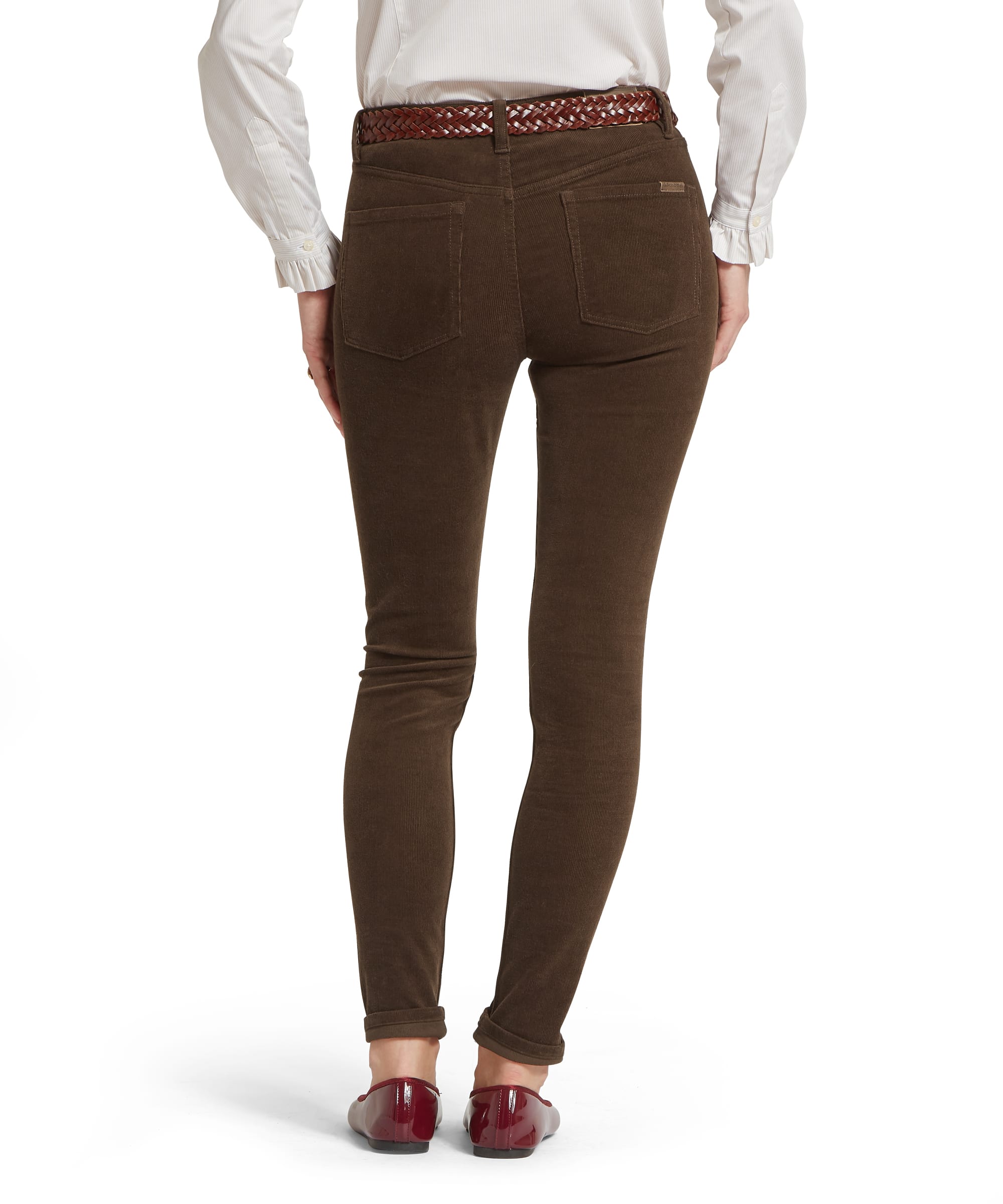 Rear view of the Women's Schöffel Clover Cord Jean in tobacco brown, showing the five-pocket styling, Schöffel branded leather patch and slim needlecord leg, worn with a white blouse and tan woven belt.