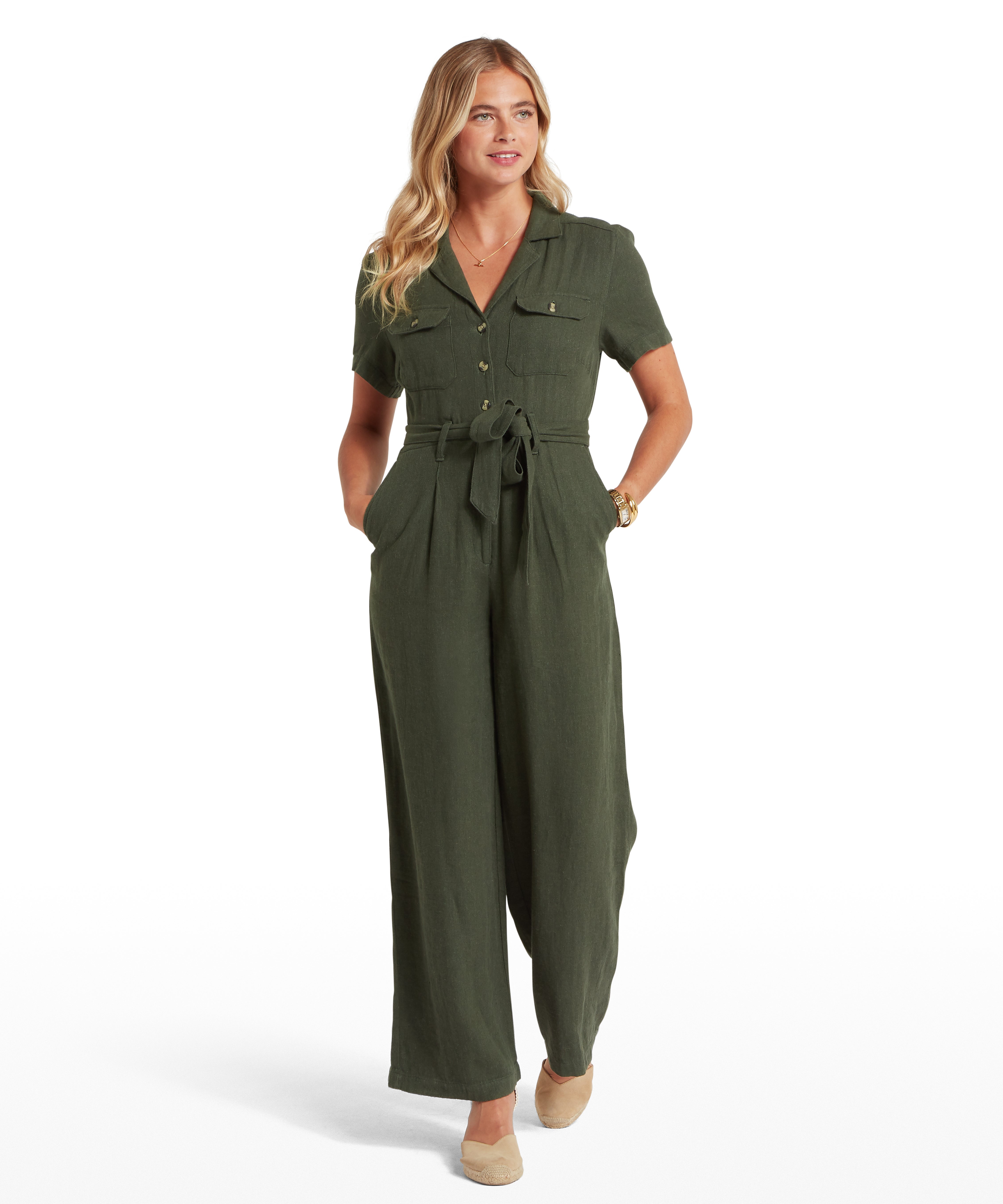 Woman wearing a green jumpsuit on a white background