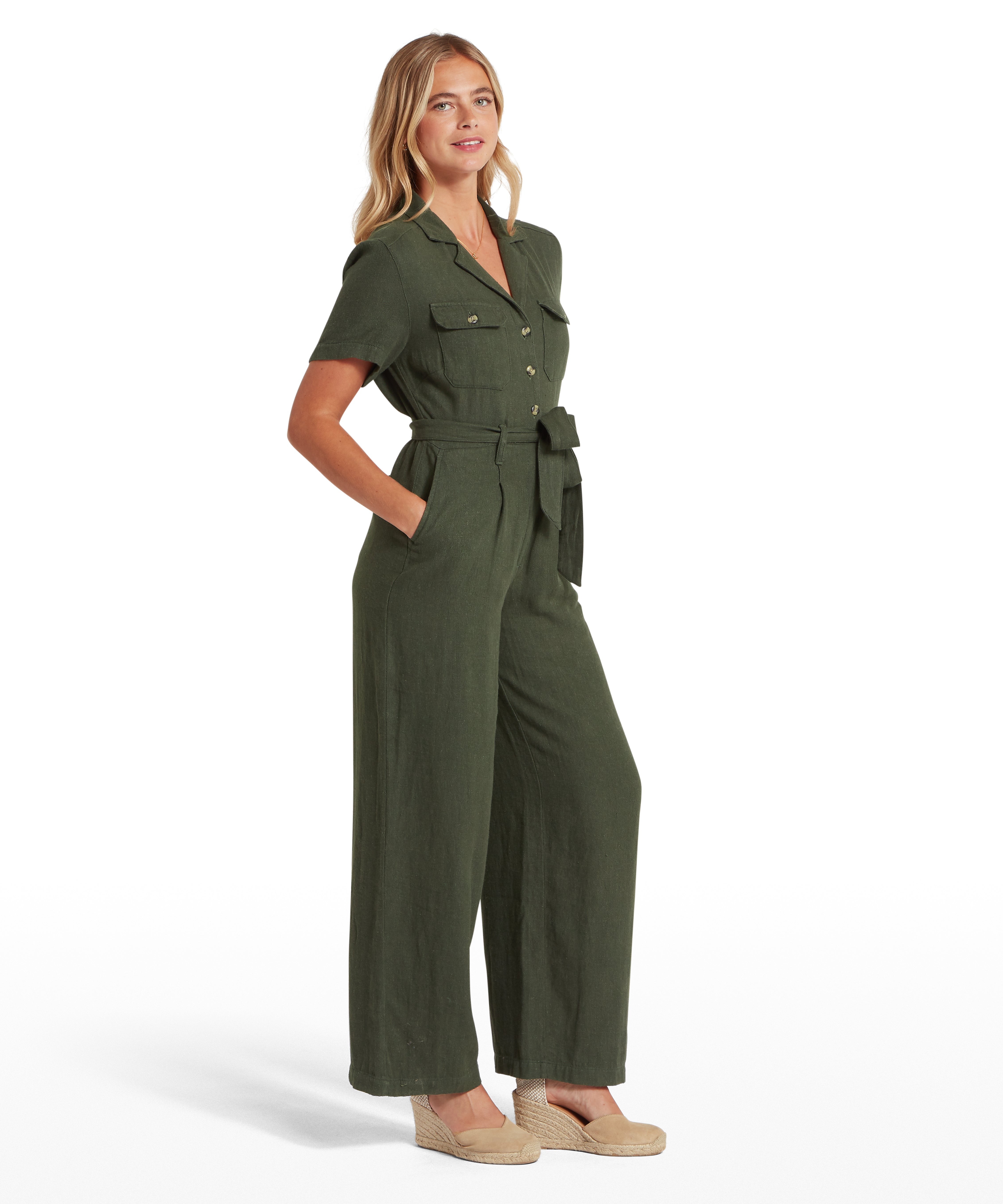 Woman wearing a green jumpsuit on a white background
