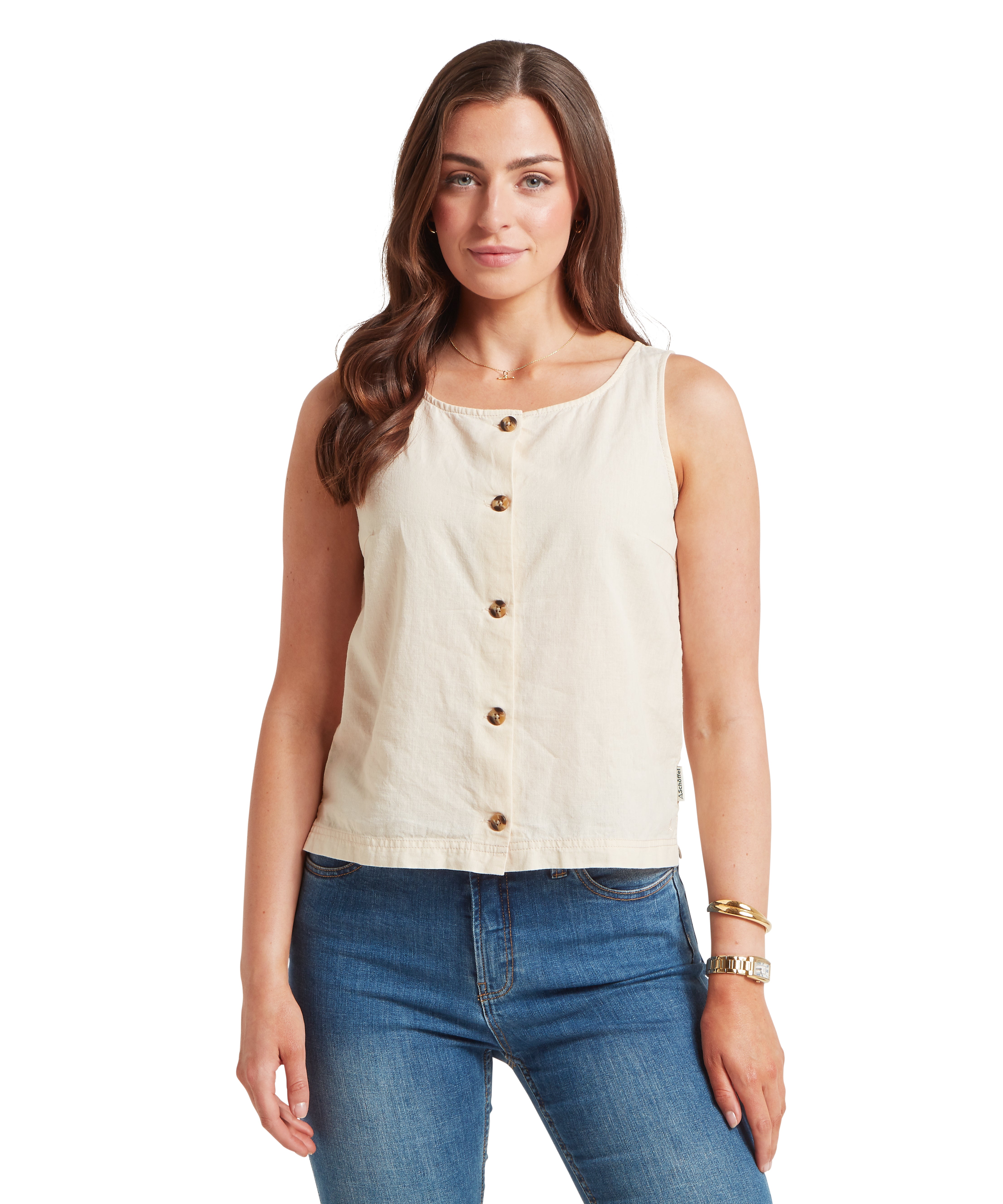 Woman wearing a beige sleeveless top with buttons and blue jeans on a white background