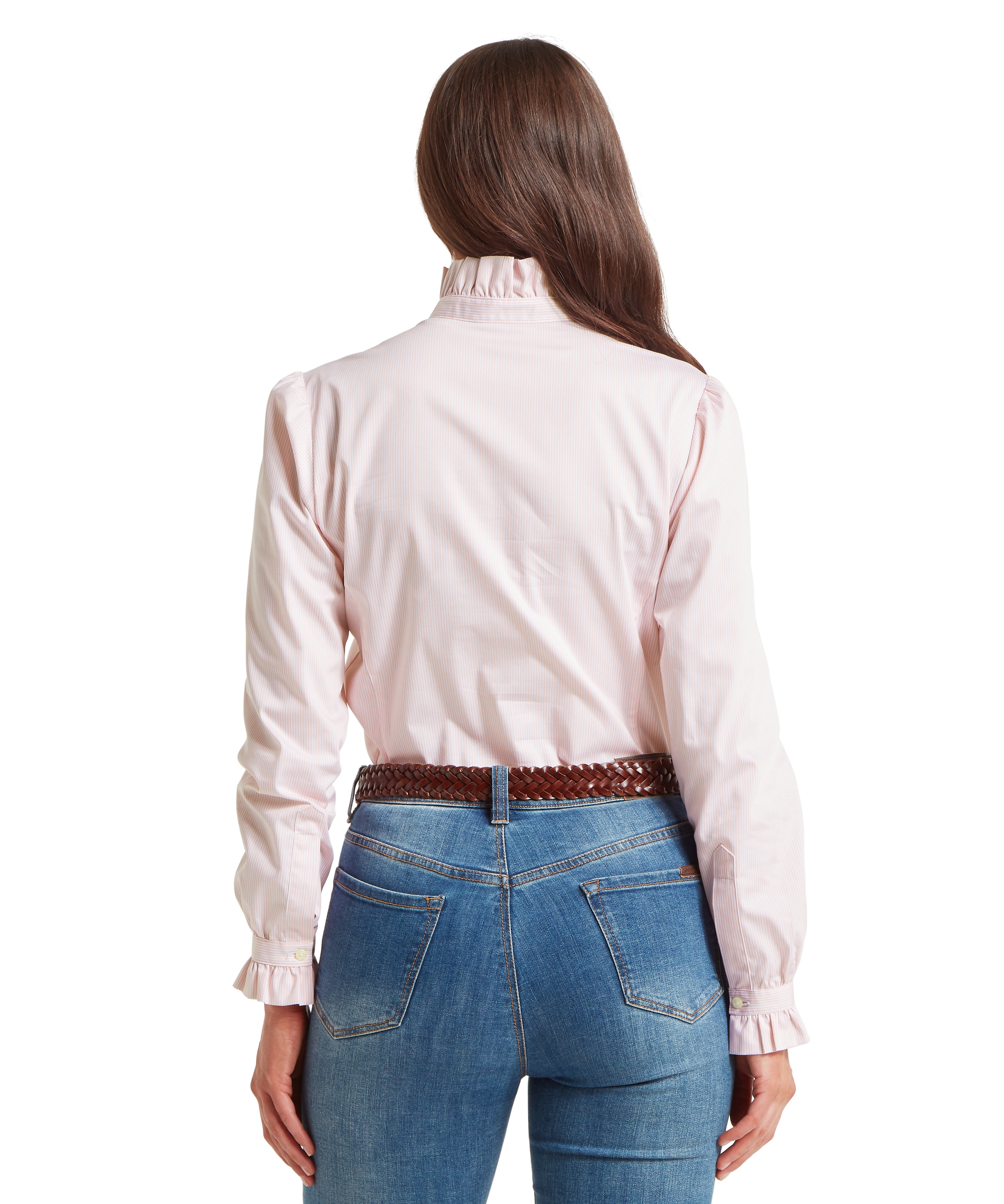 Woman seen from behind wearing a pale pink and white vertically striped blouse with a high ruffled collar and ruffled cuffs. Her long brown hair is styled over her right shoulder, and the blouse is tucked into blue denim jeans which are secured with a brown woven leather belt. The image highlights the tailored fit of the blouse across the shoulders and back, showing the delicate pattern extending down to the waist.
