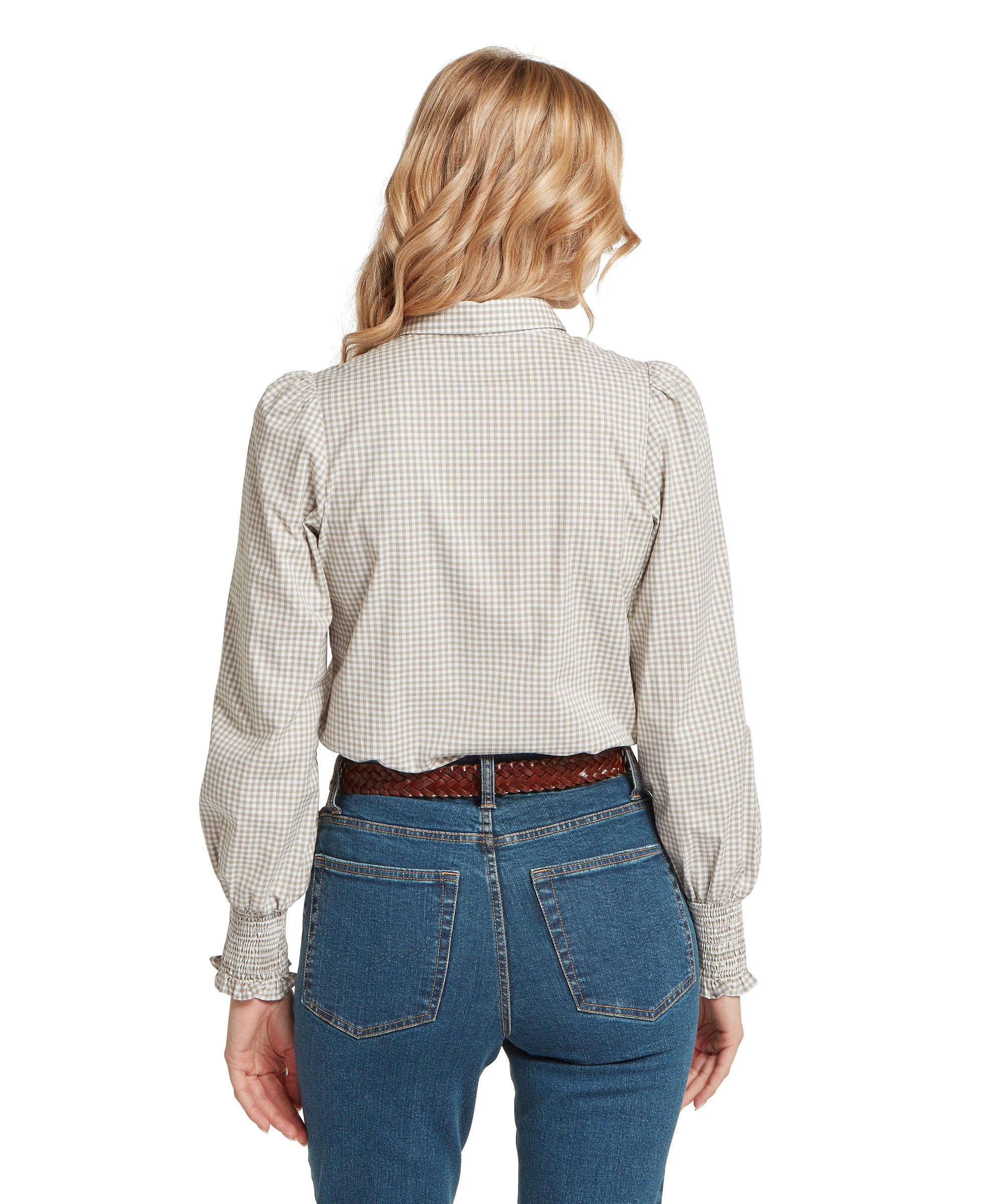 A woman wears a flora gingham shirt in sage green with puffed sleeves and smocked cuffs in light