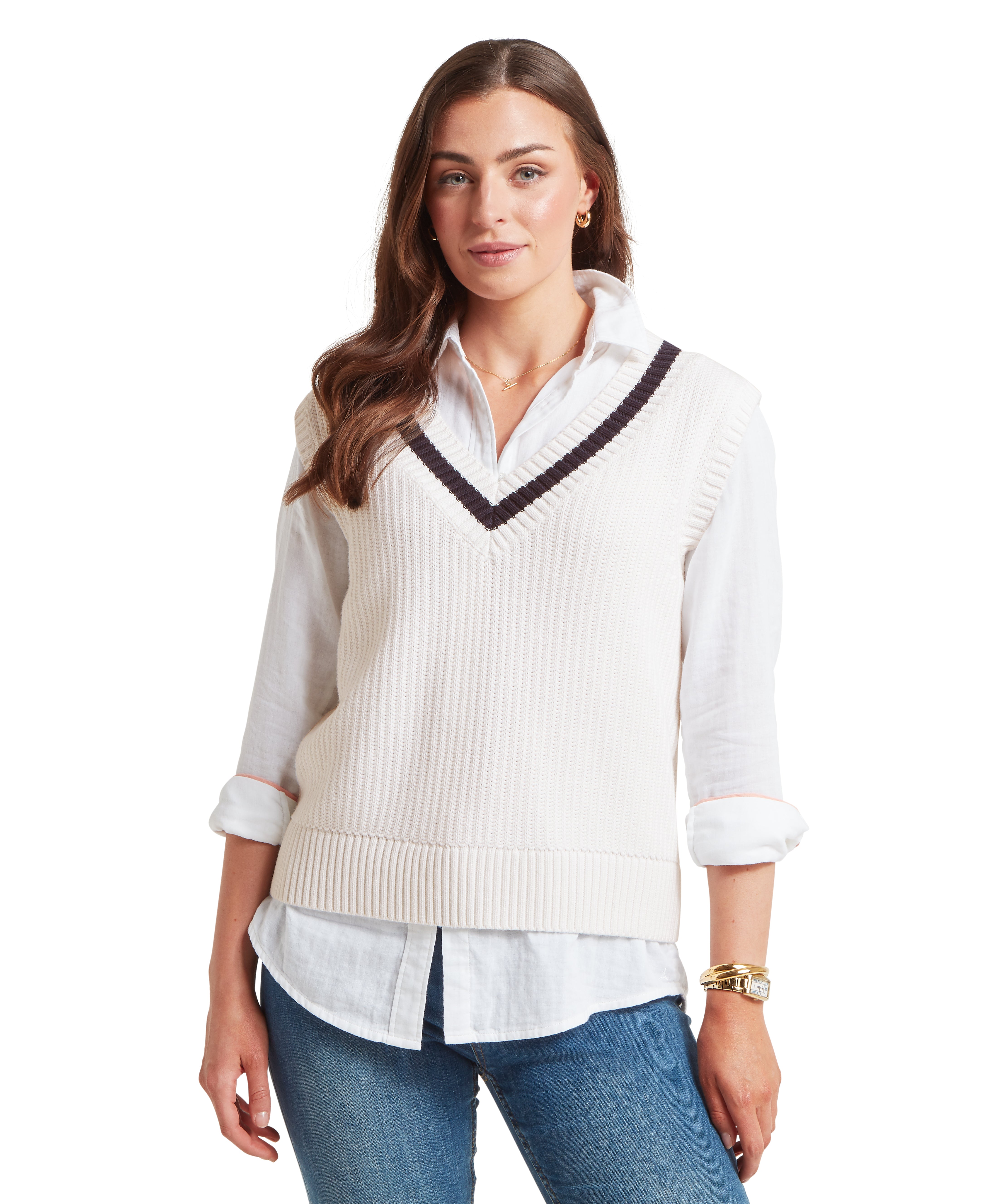 Woman wearing a white shirt with a V-neck jumper over it on a white background