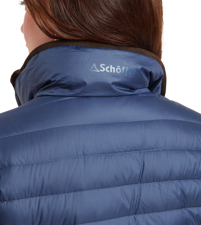 Rear detail of Schöffel Women's Hambleton Down Jacket in steel blue, showing the quilted baffles, contrast brown collar trim and Schöffel logo print